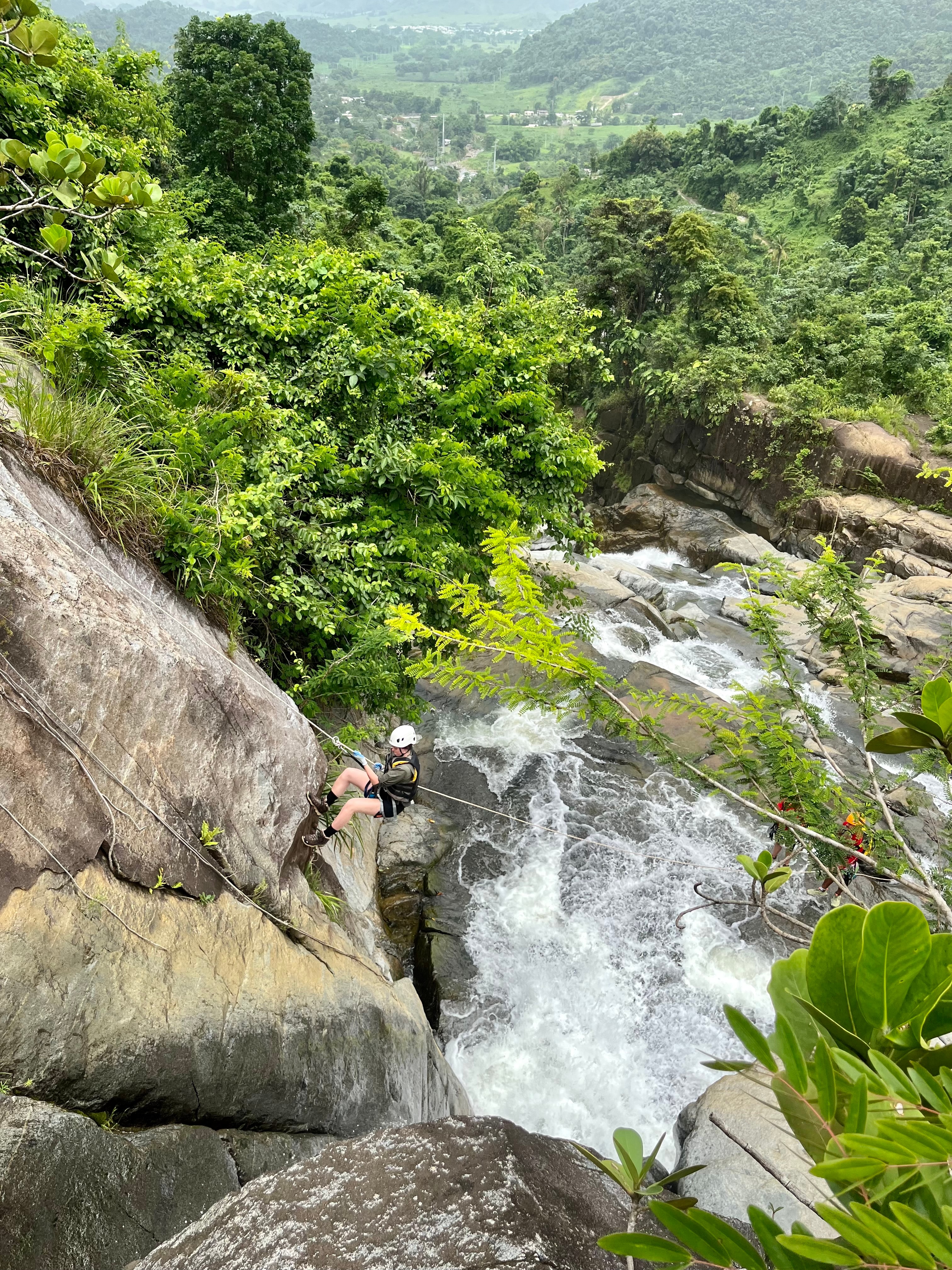 A view of a waterfall in the jungle on a cloudy day