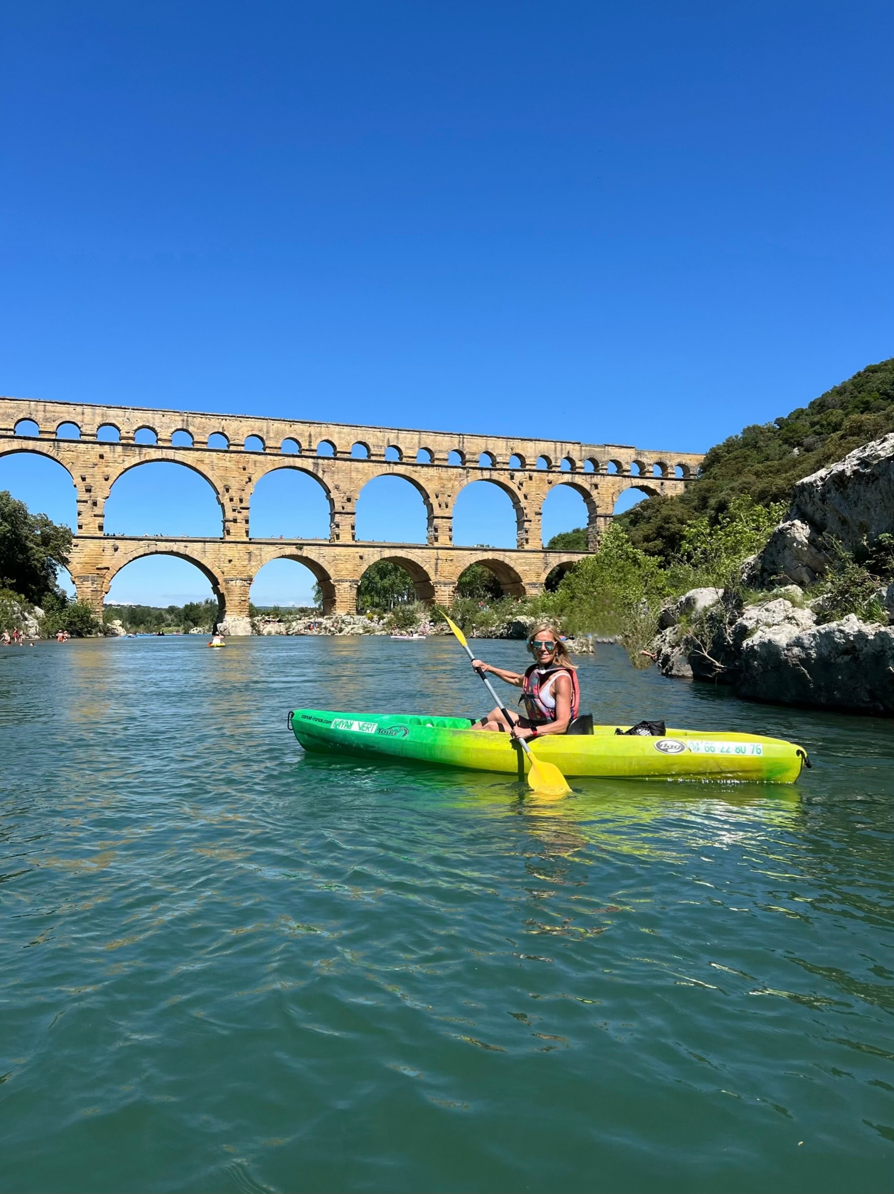 Kayak by a bridge.