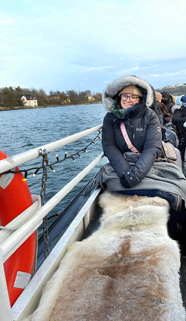 Advisor posing for an image on a boat. 