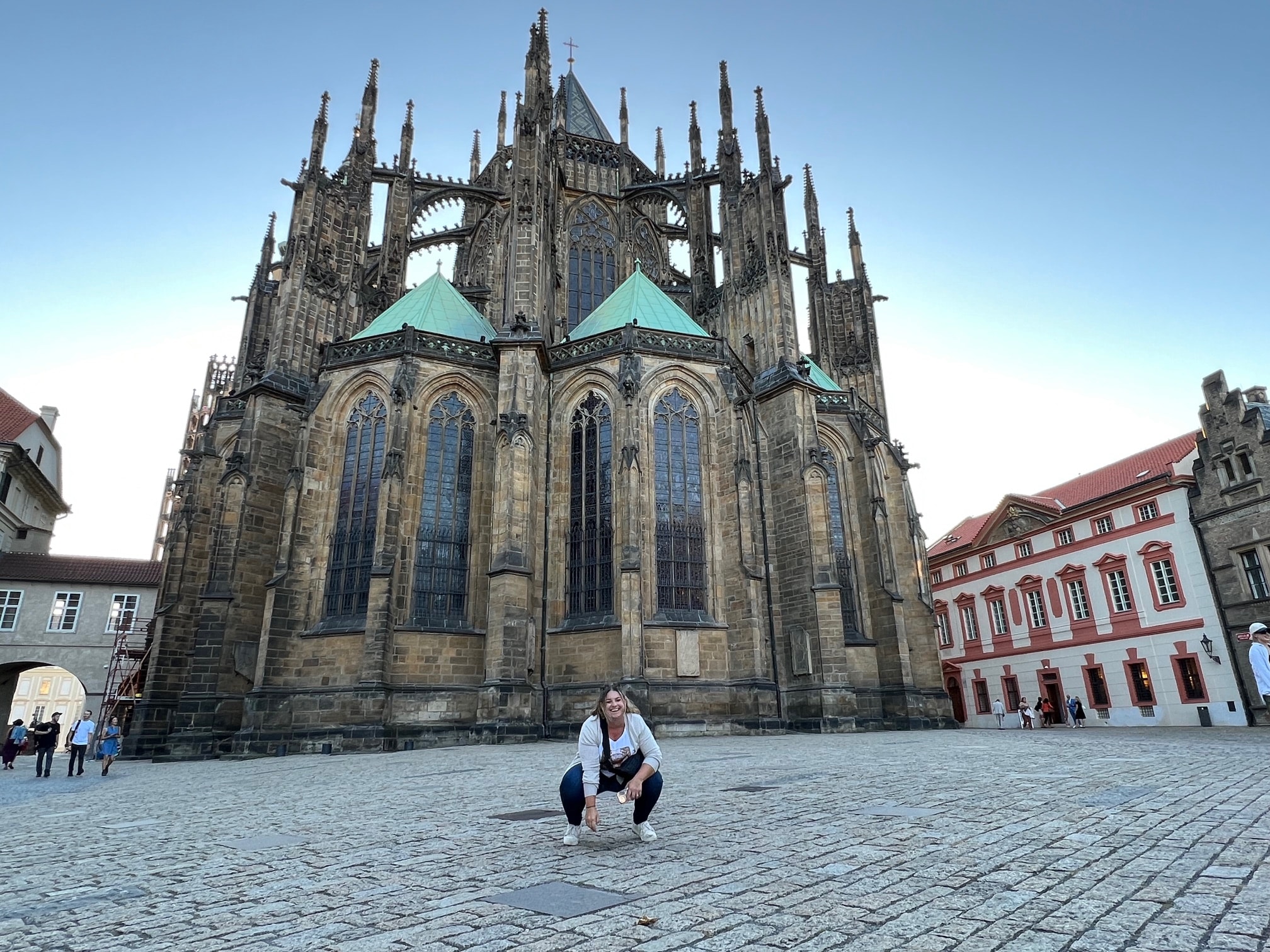 Advisor posing for an image with a cathedral in the distance.