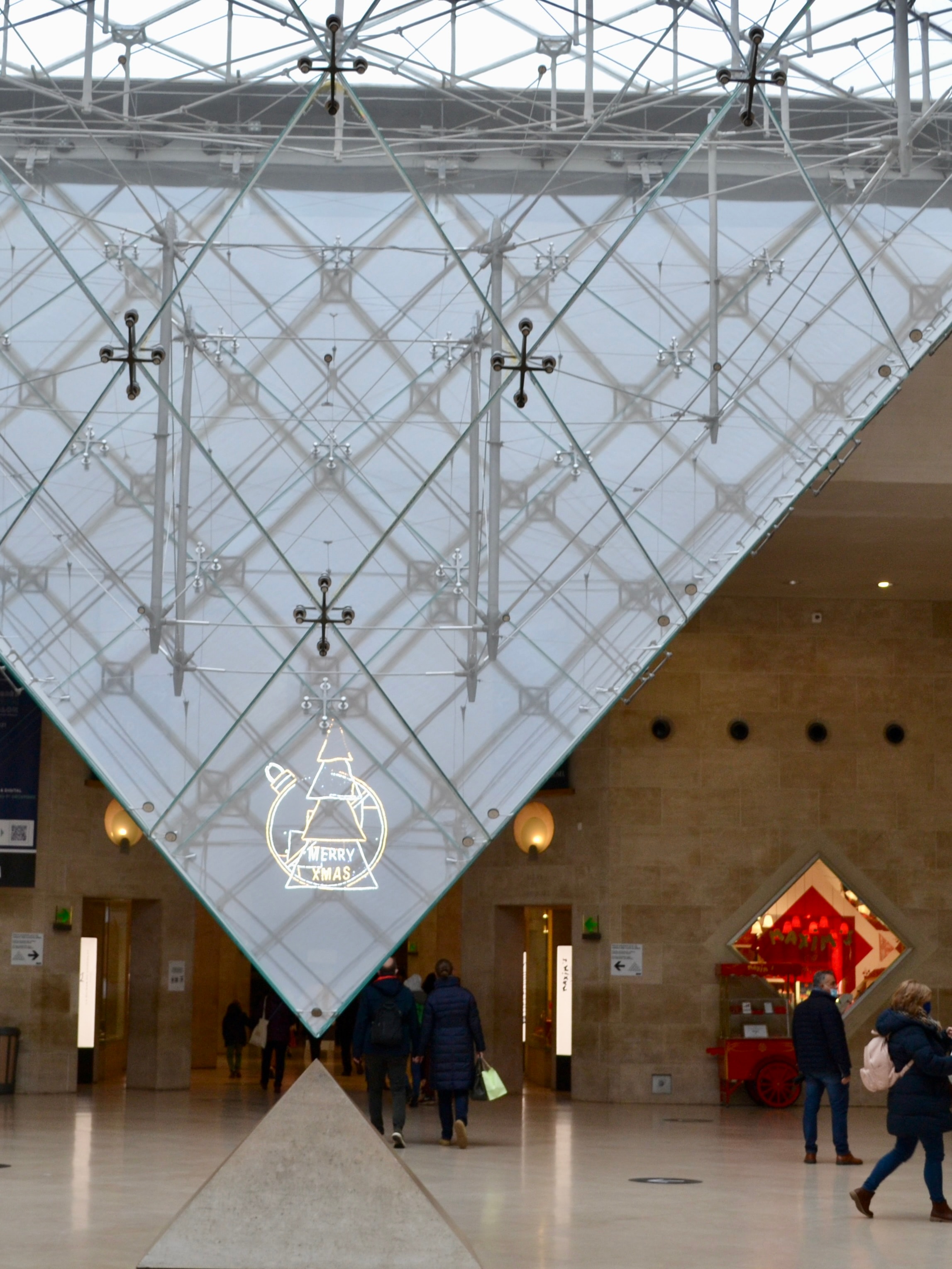 A view of the inside of a building with a large art display. 