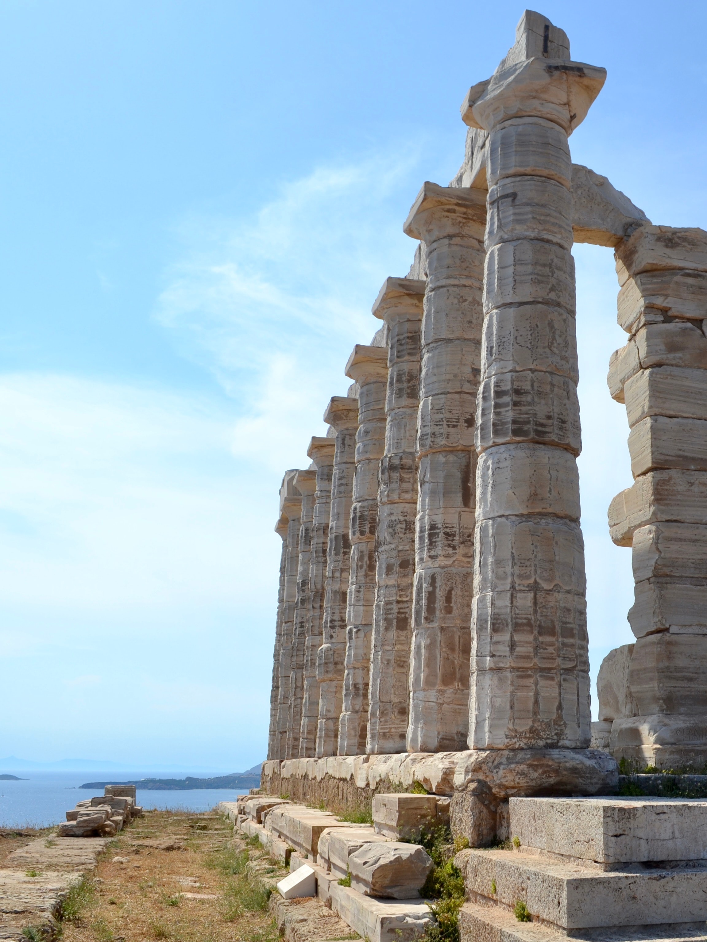 A view of ancient columns during the daytime. 