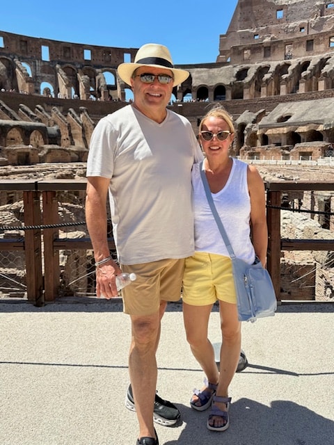 Advisor and partner posing side by side inside the Colosseum during the day