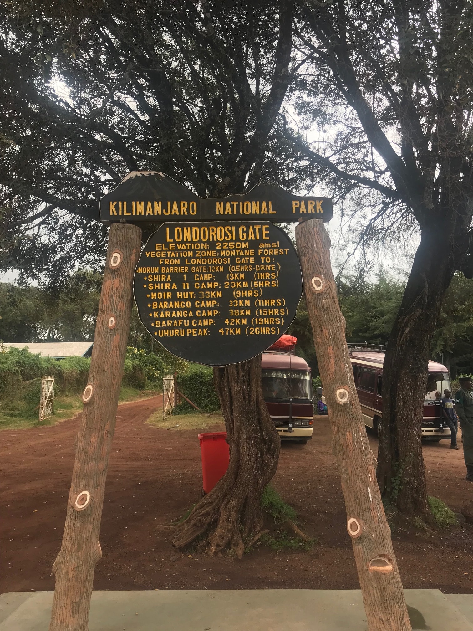 View of a sign for Kilimanjaro National Park and trees