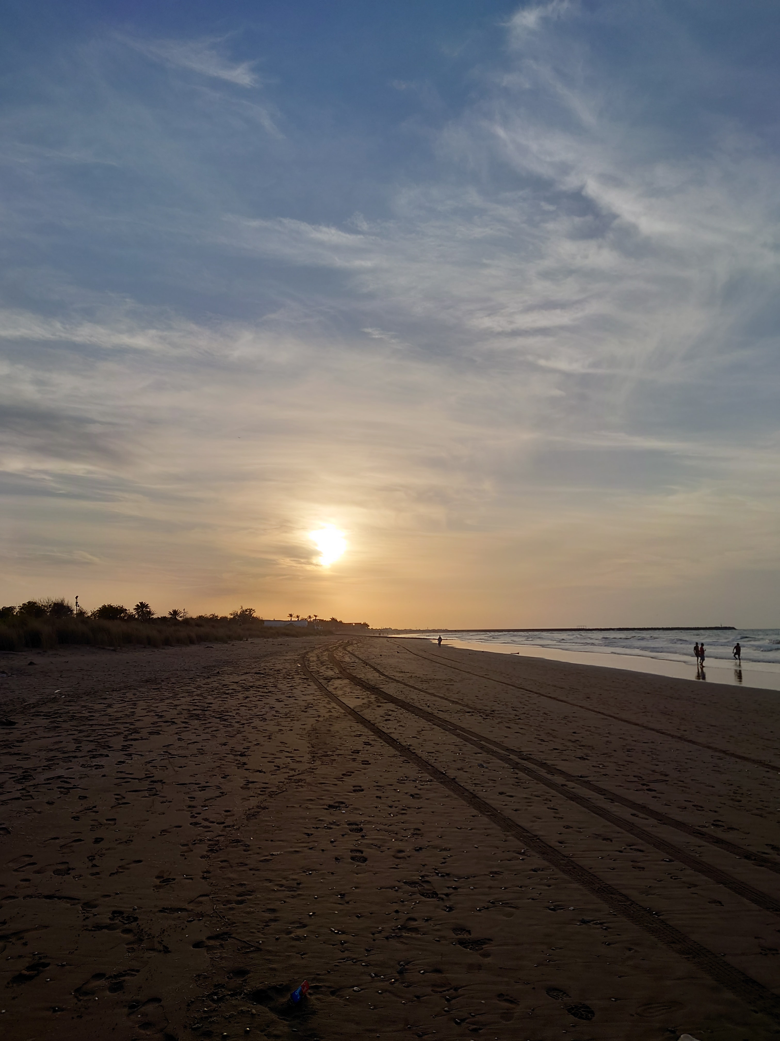 View of the sunset over a wide empty beach