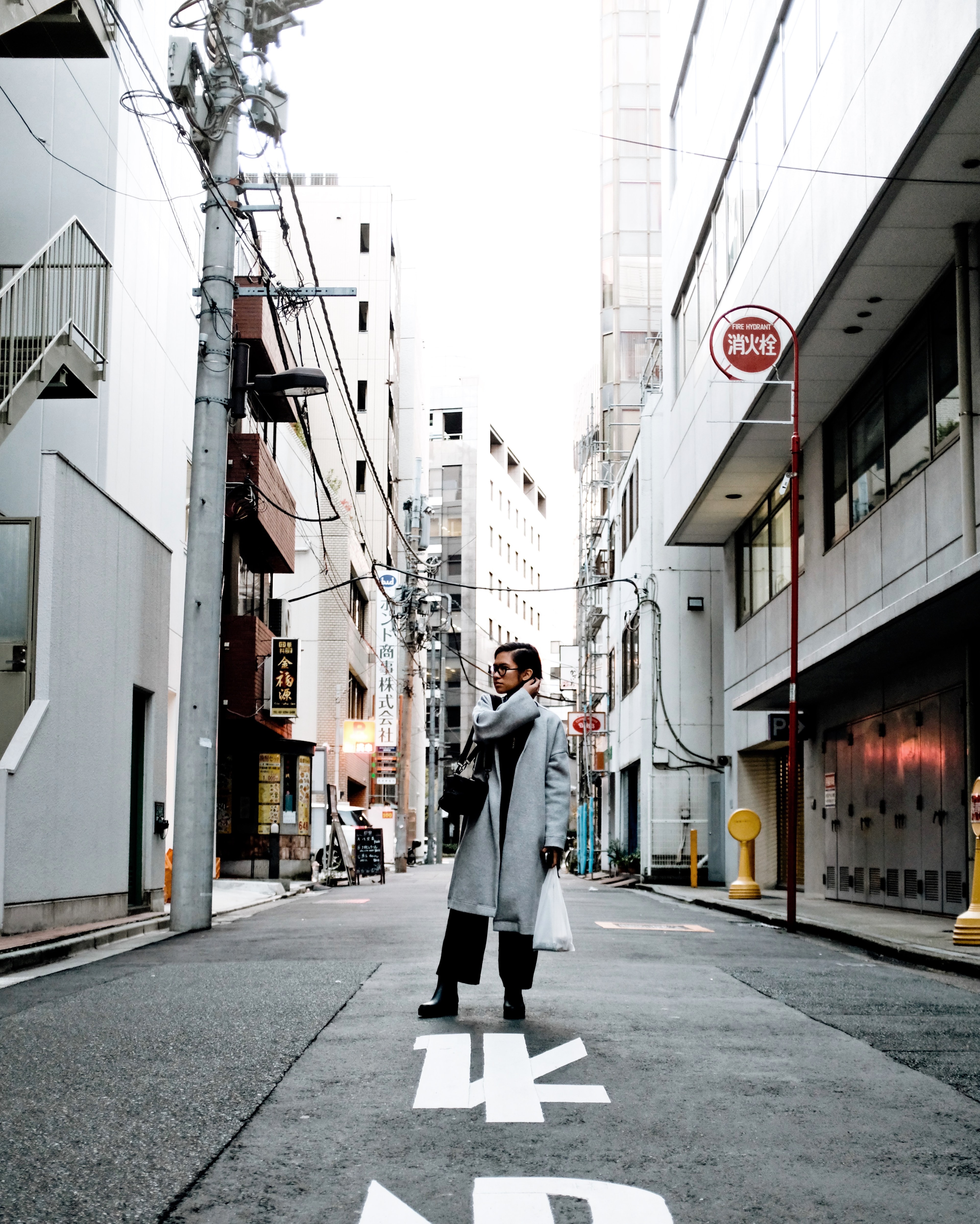 Advisor standing on the street in Japan on a cloudy day