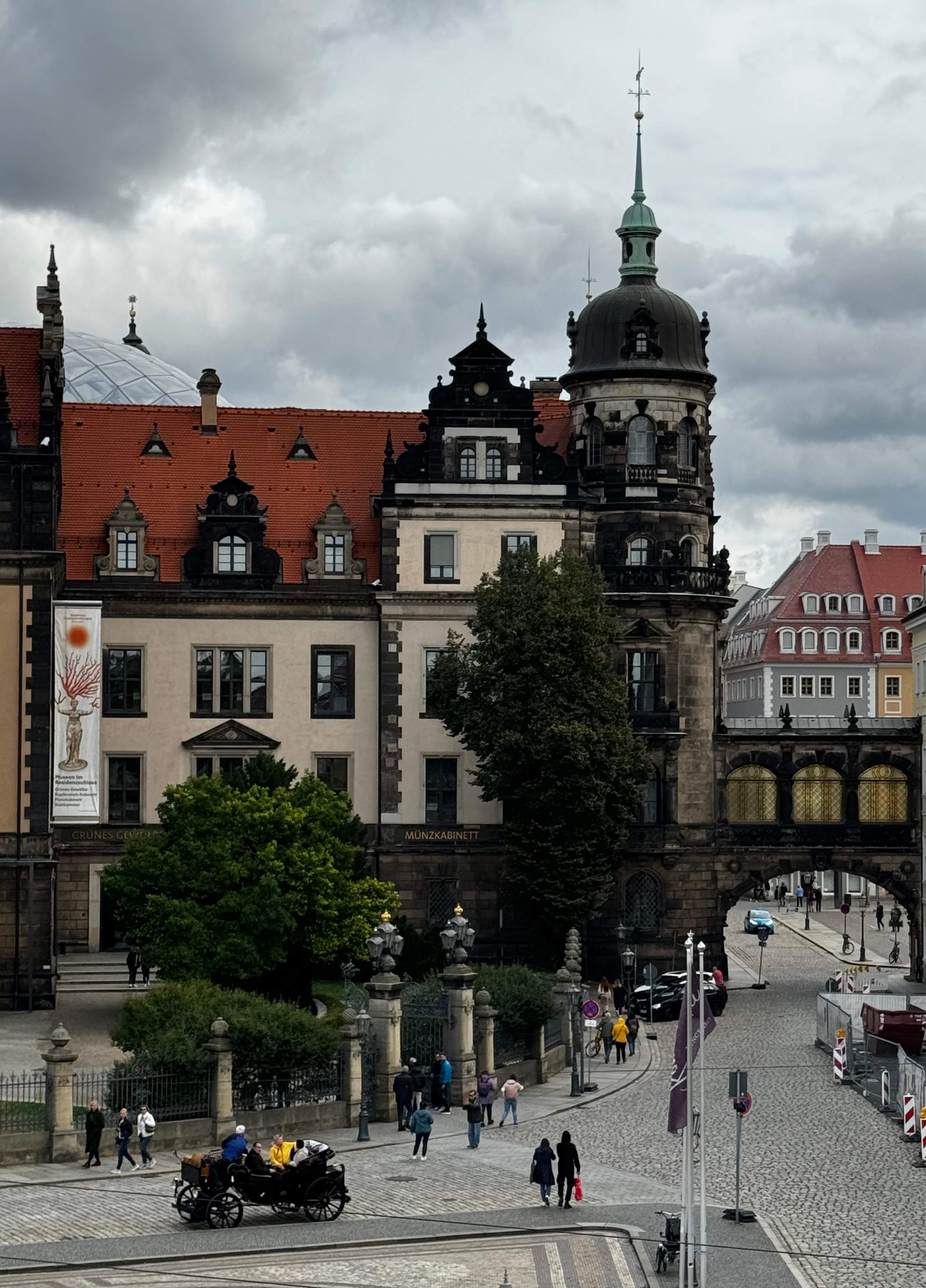 A bustling city street featuring a bridge and various buildings lining the sides.