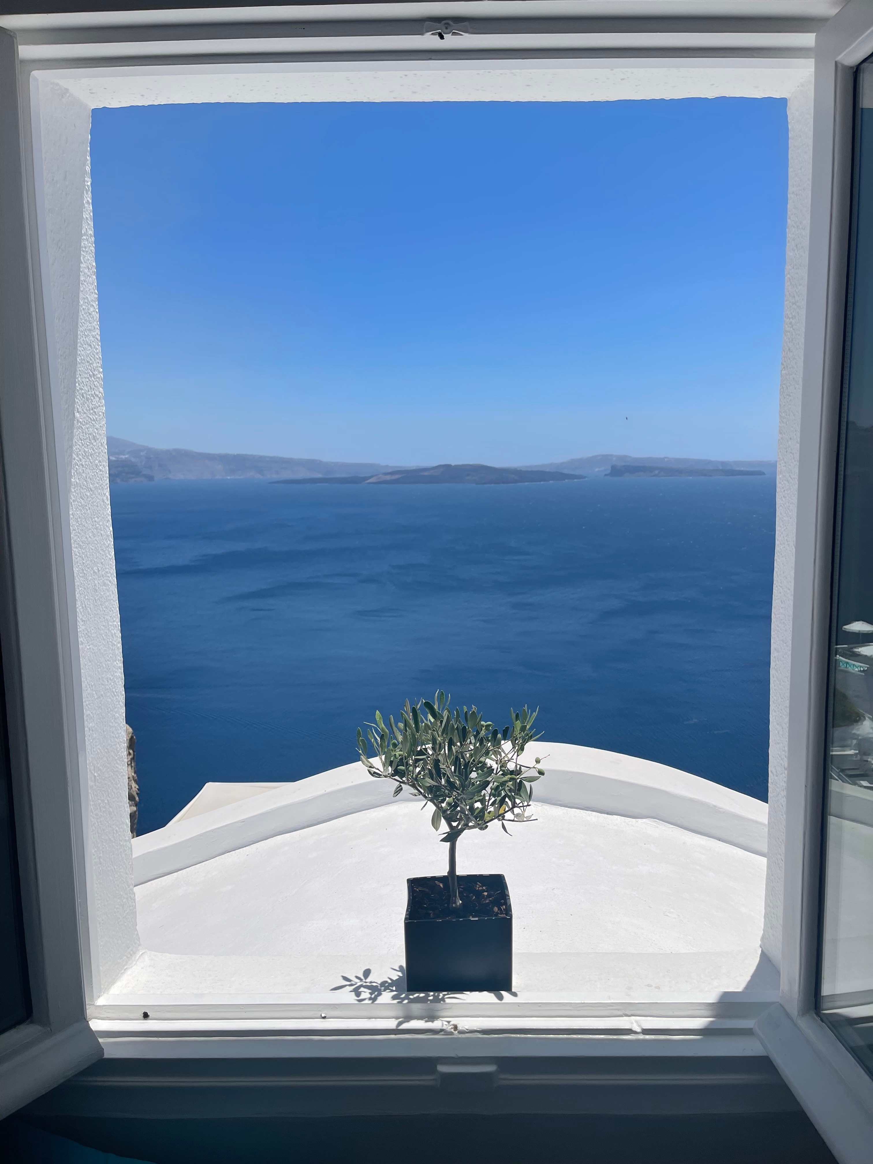 View of the ocean and clear skies as seen from a window