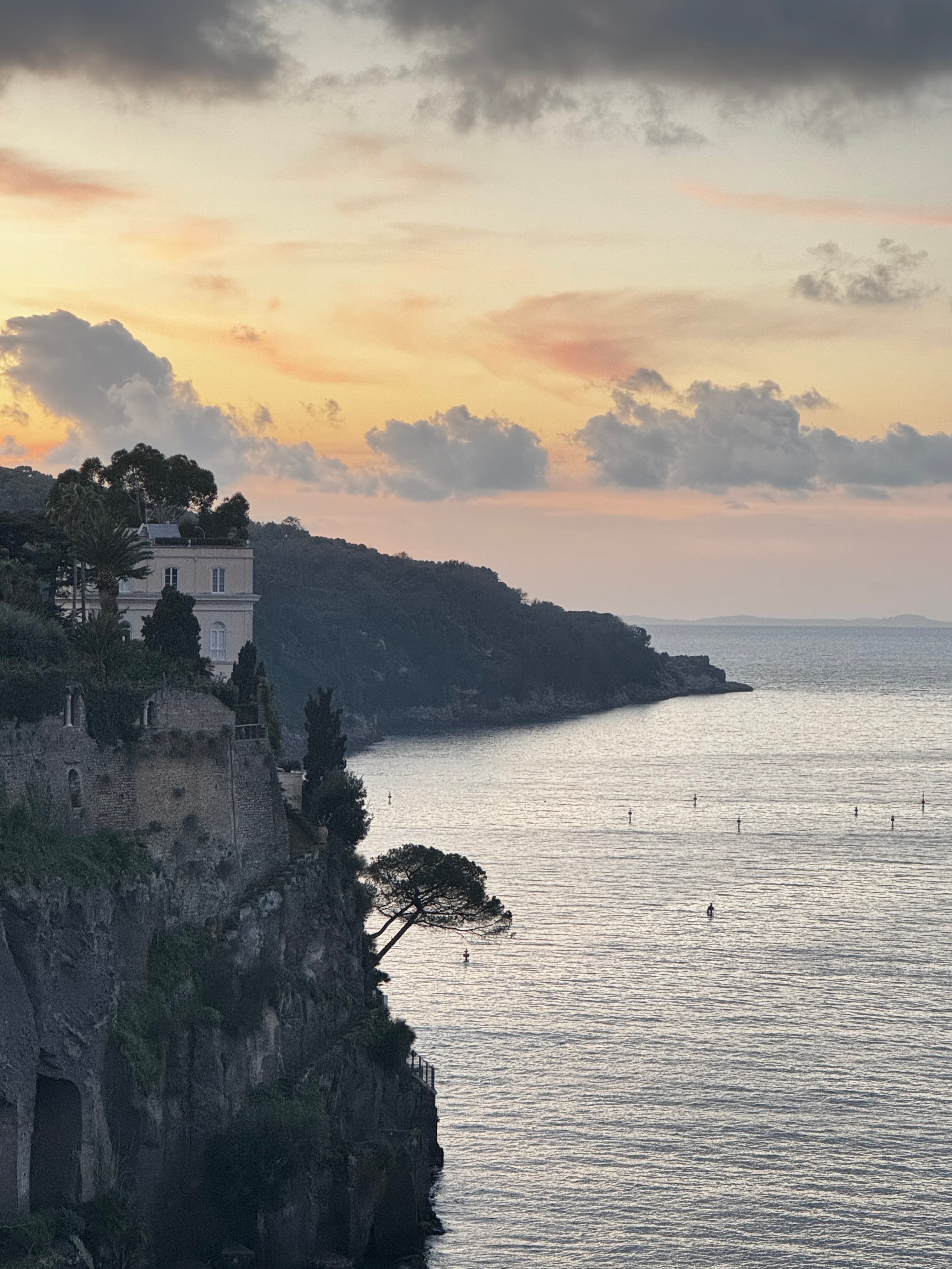 View of a coastline with tall cliffs at sunrise