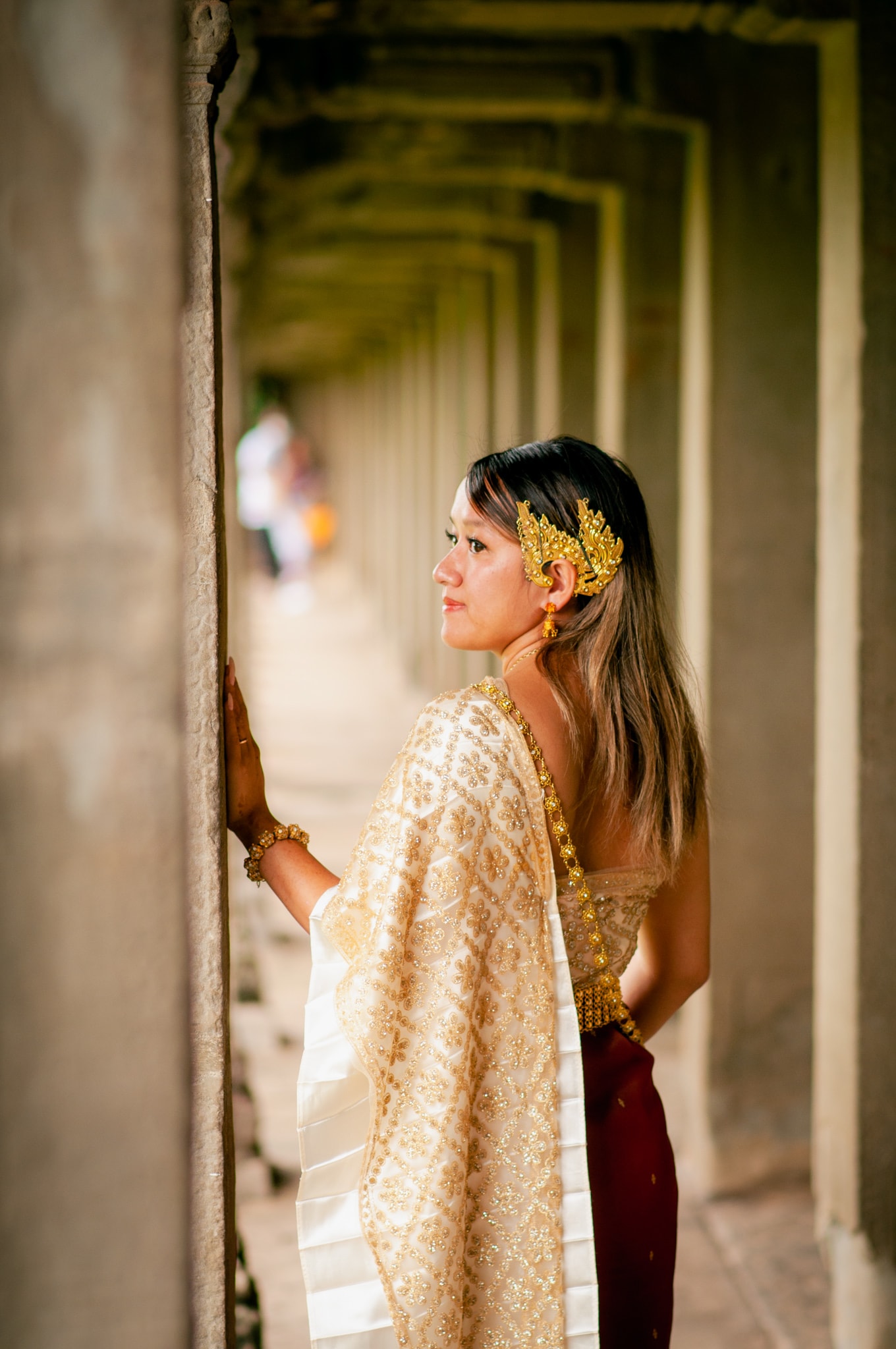 Advisor in a traditional dress looking over her shoulder in an outdoor hallway