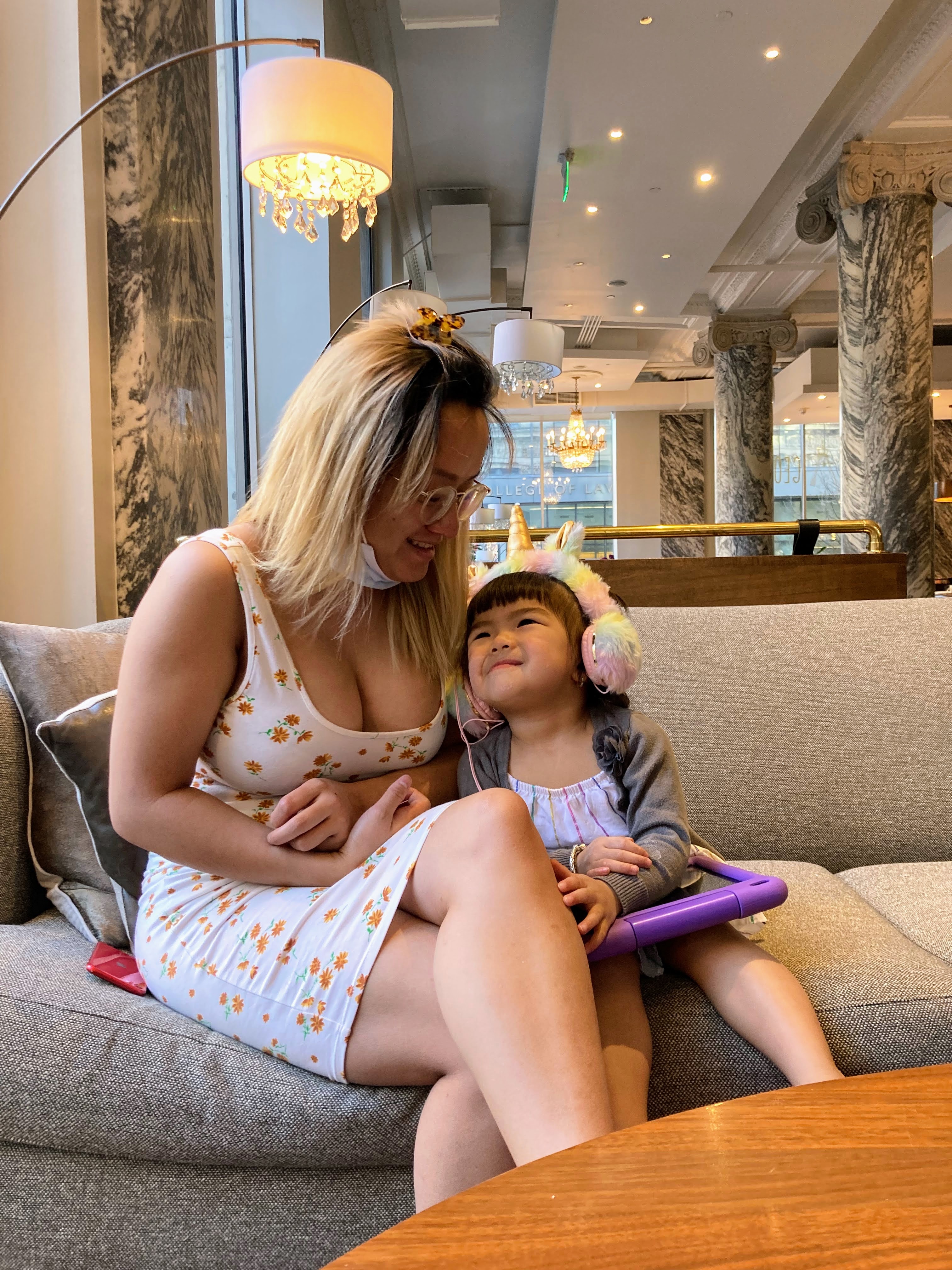 Advisor and daughter sitting side by side on a couch indoors