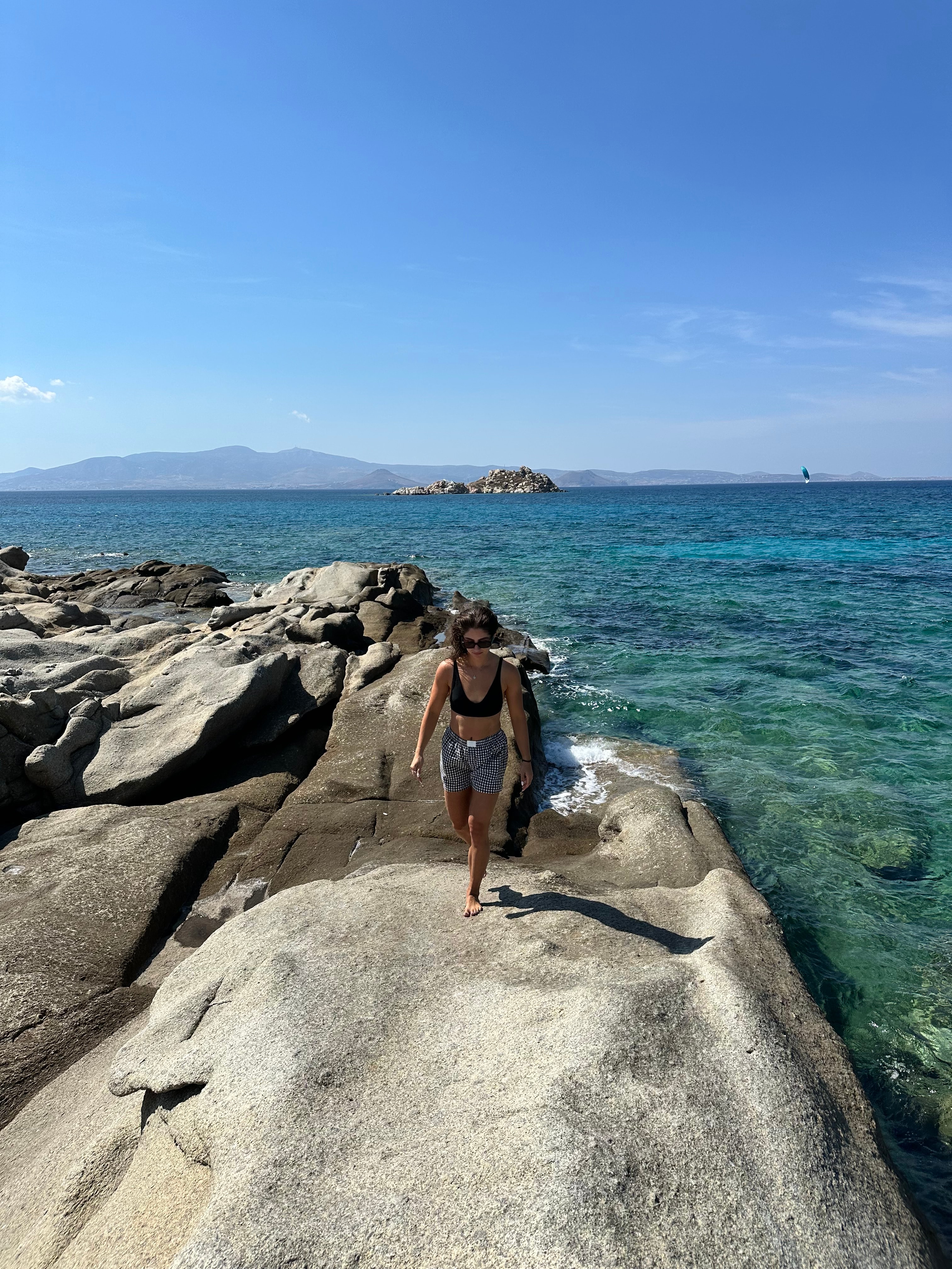 Walking on rocks by the sea.