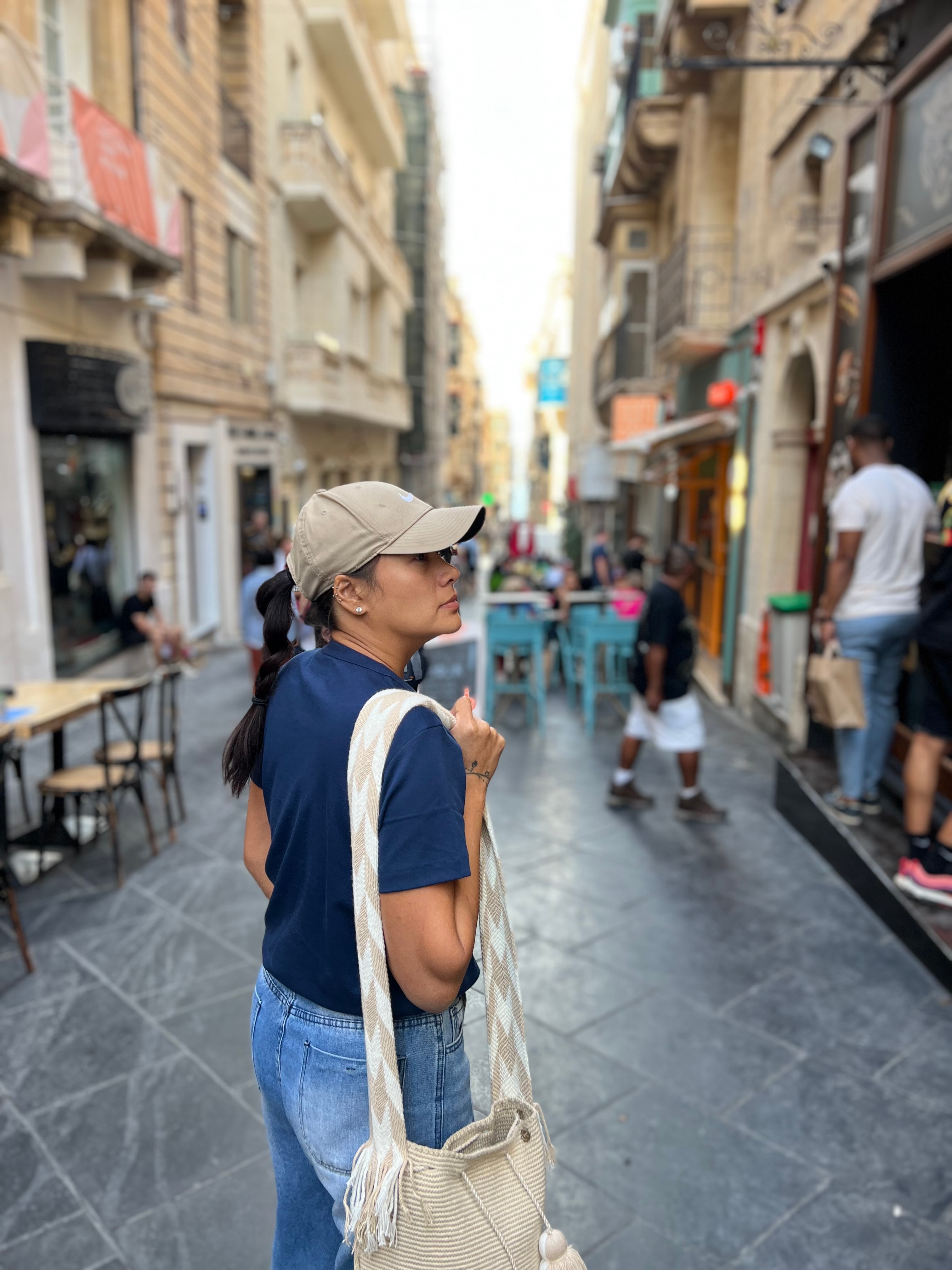 Advisor carrying a bag while walking down a city street during the day