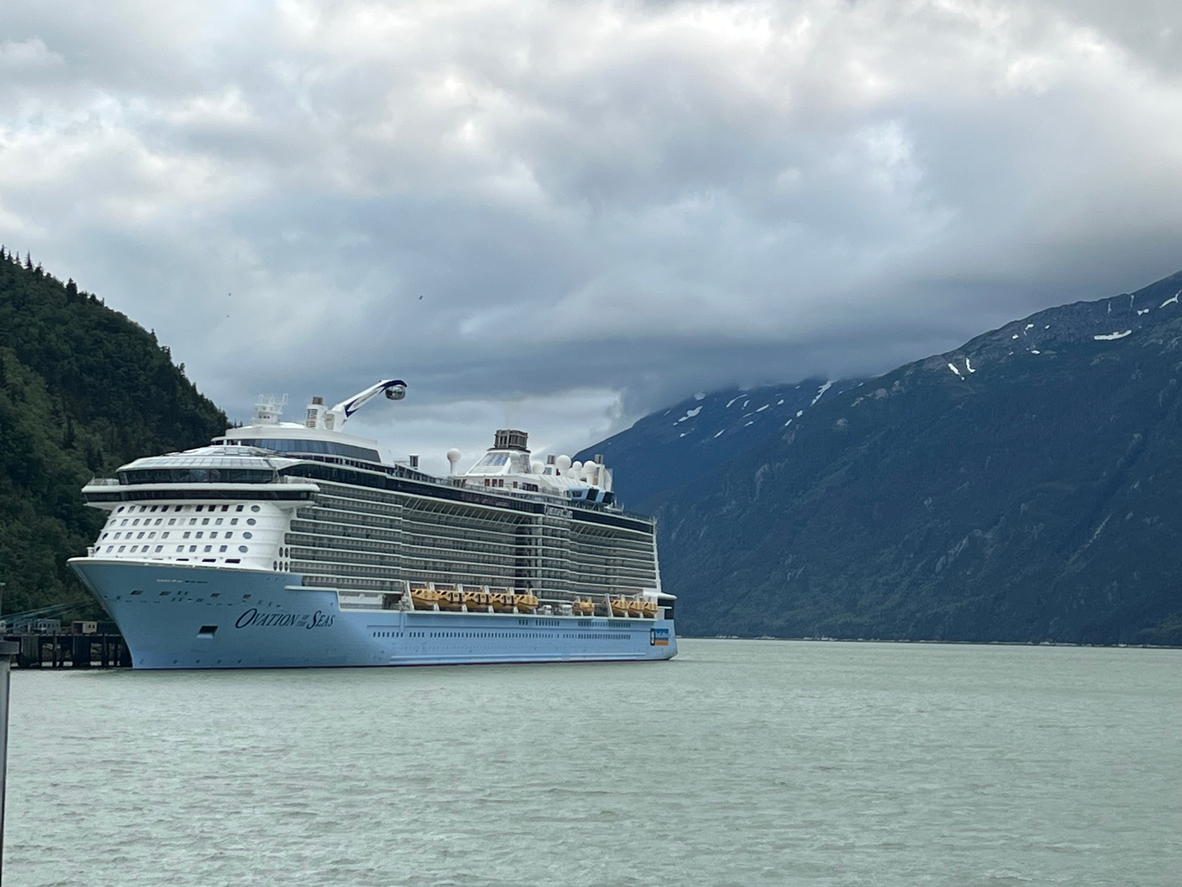 View of a cruise ship at sea under cloudy skies