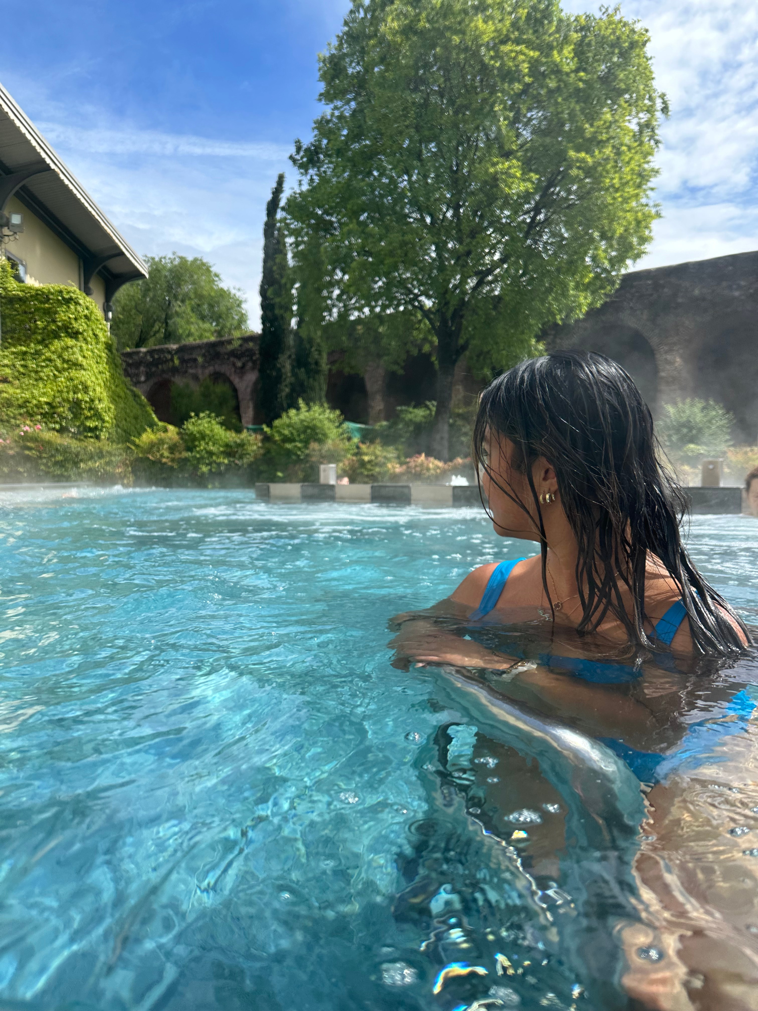 Advisor in a swimming pool surrounded by plants on a sunny afternoon