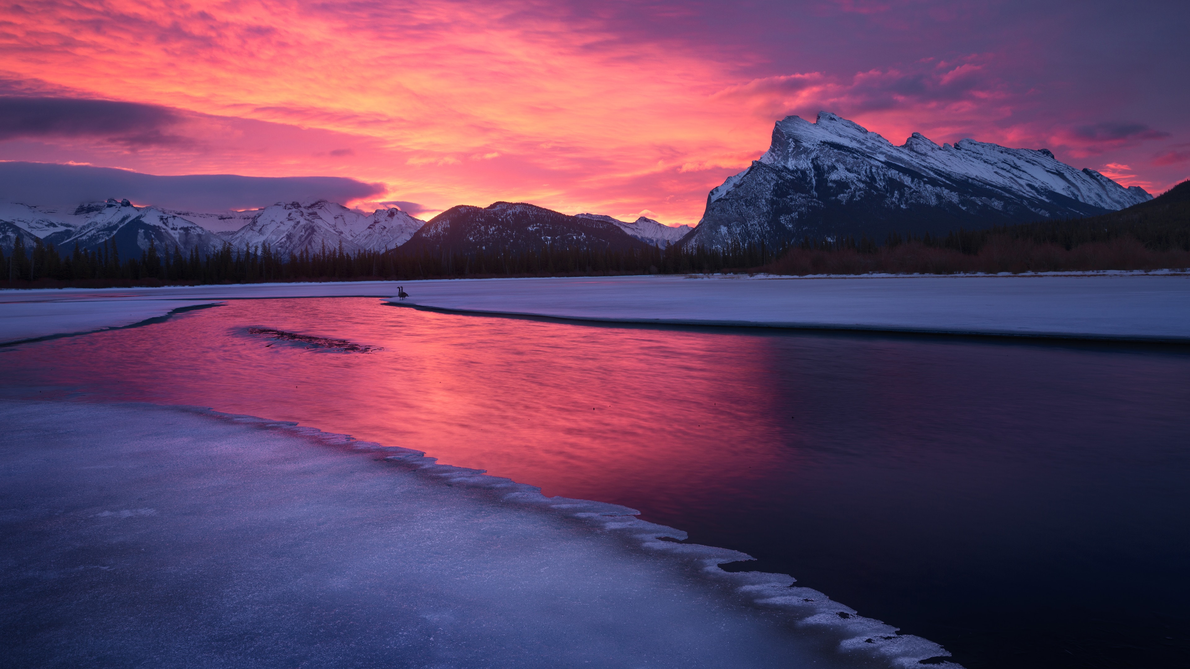 Pink skies over icey lake.