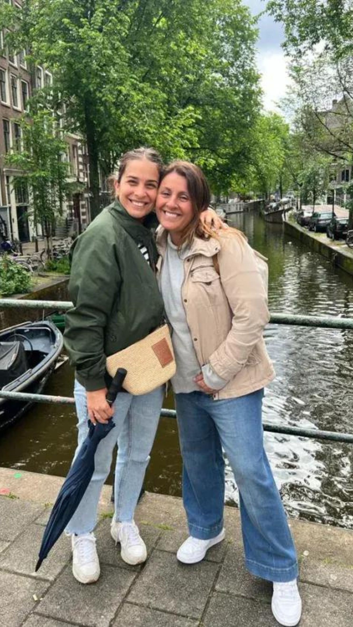 Advisor and daughter posing side by side on a bridge in Amsterdam