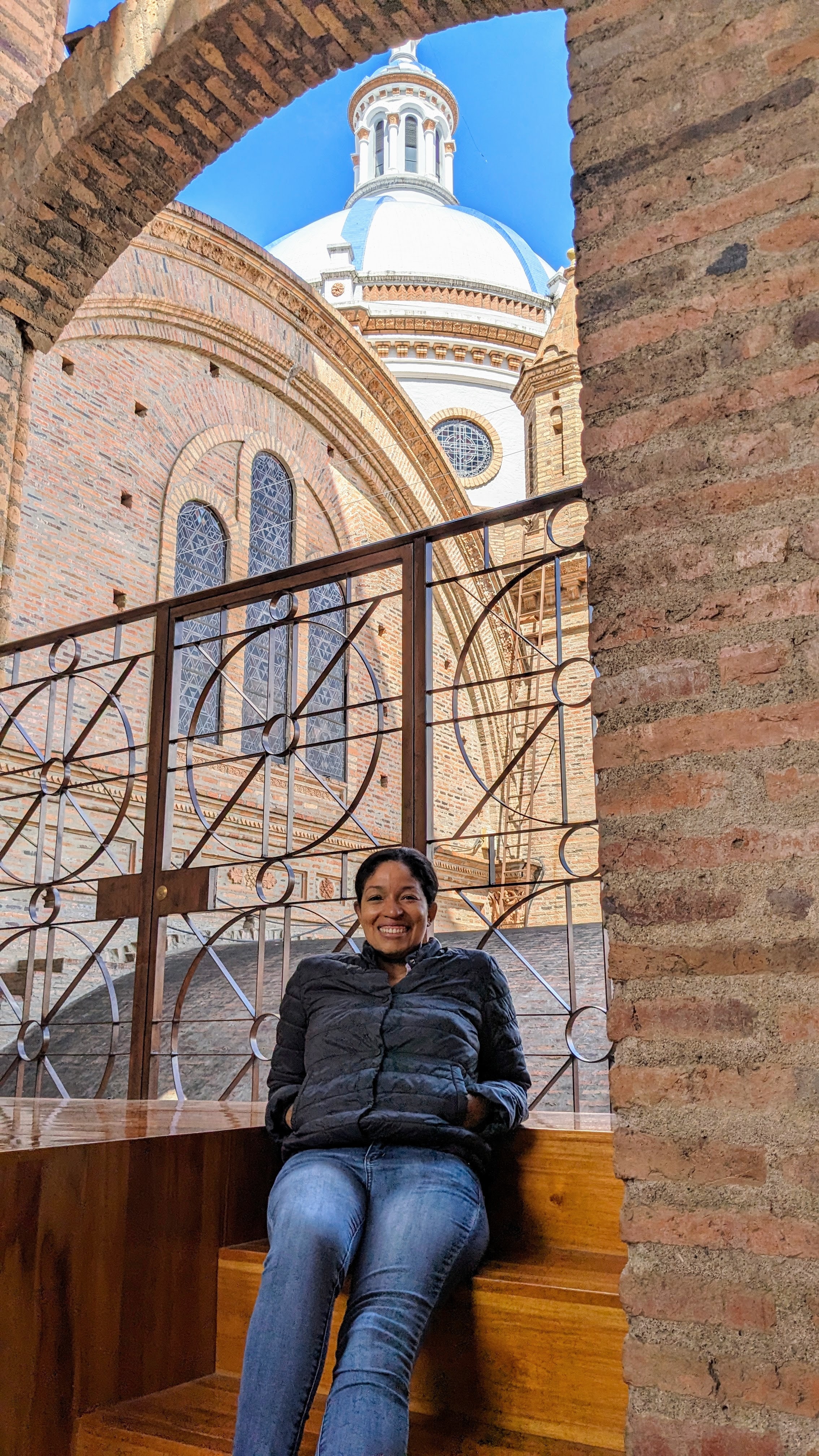 Advisor sitting on a bench by an old cathedral on a sunny day