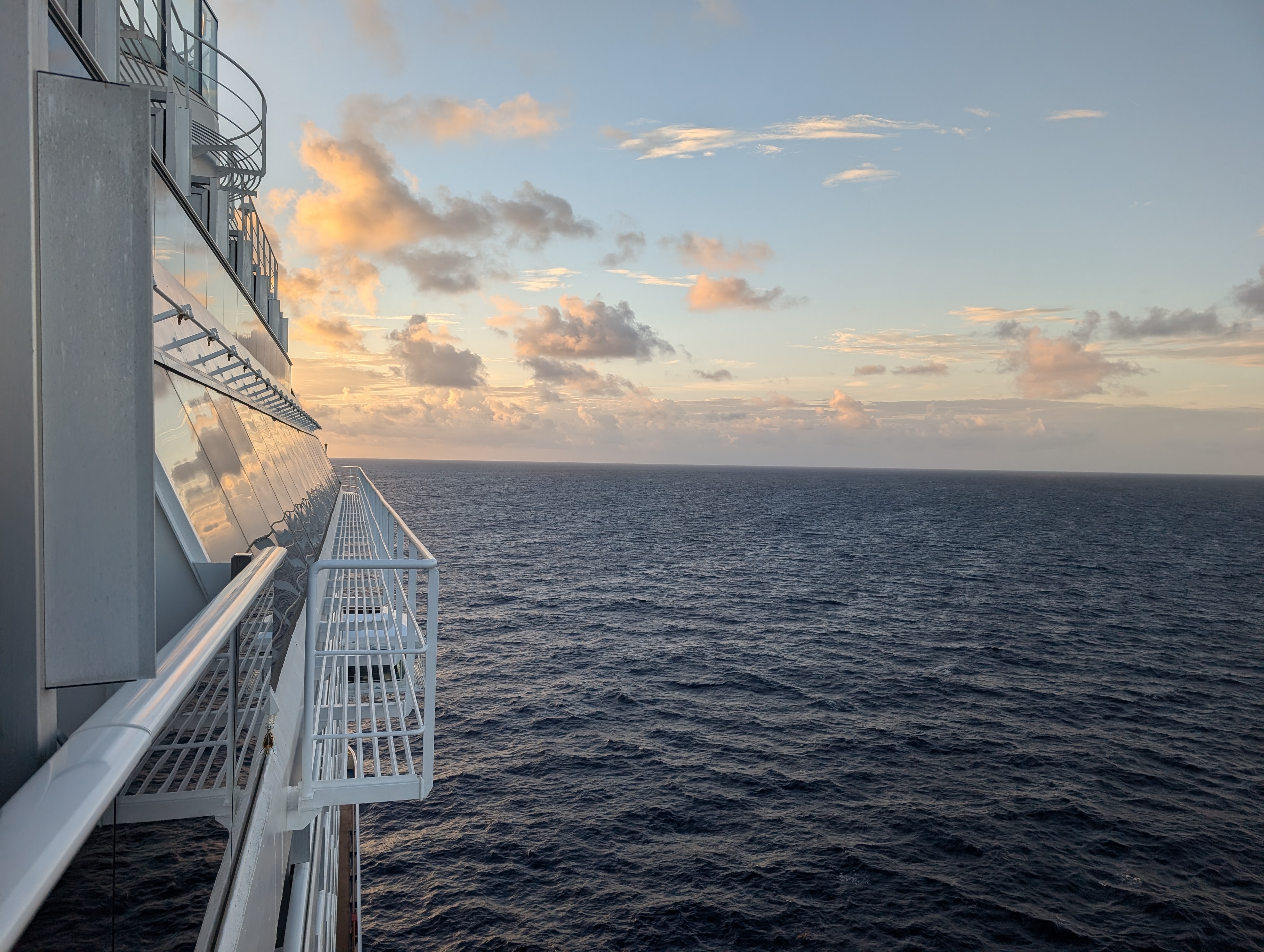 View of the ocean seen from the deck of a cruise ship at dusk