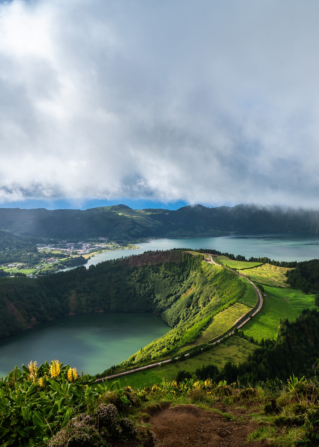 Aerial view of a green cliffs and two bays under cloudy skies