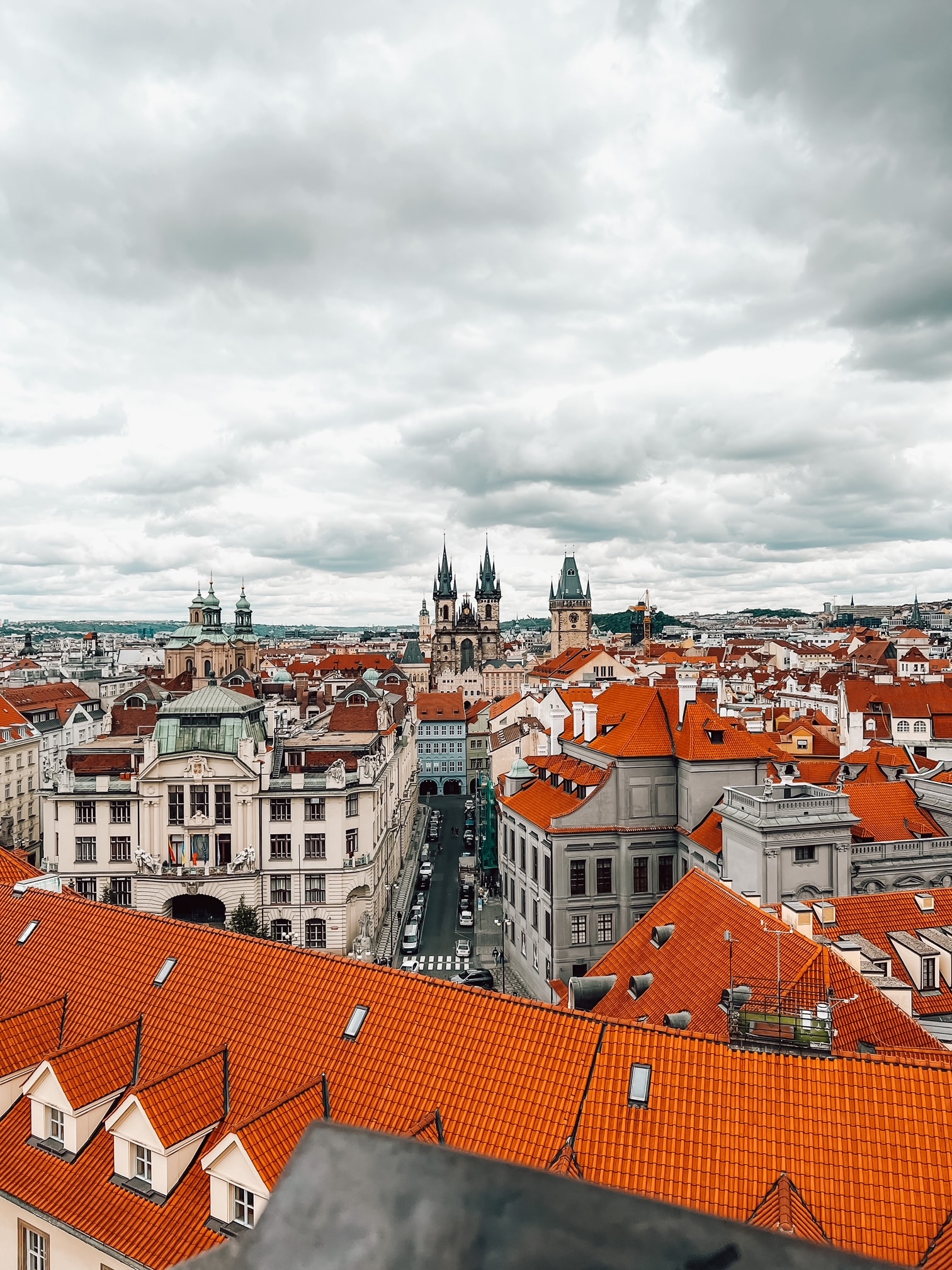 View of orange rooftops in a beautiful city on a cloudy day