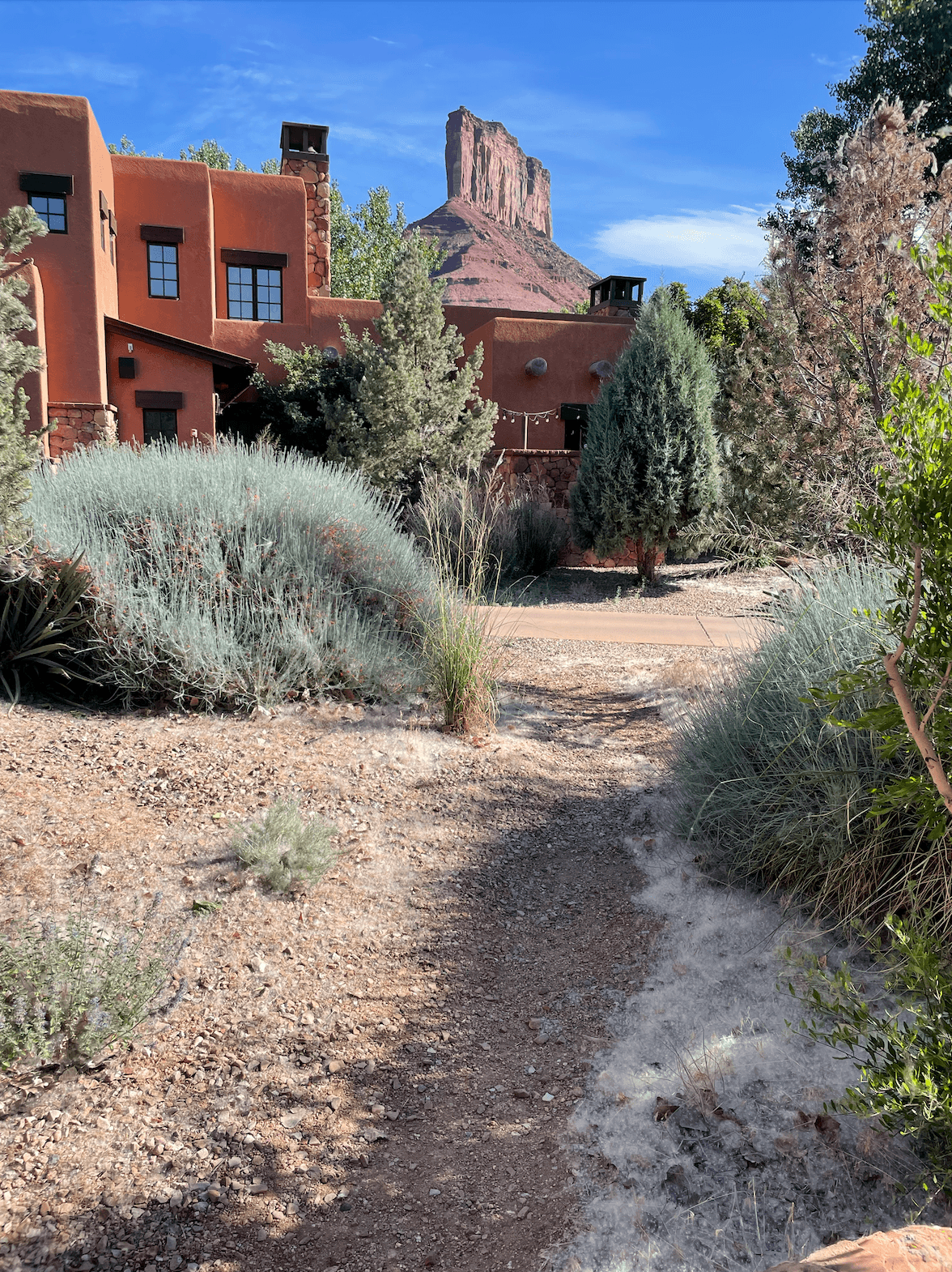 Red house by trees.