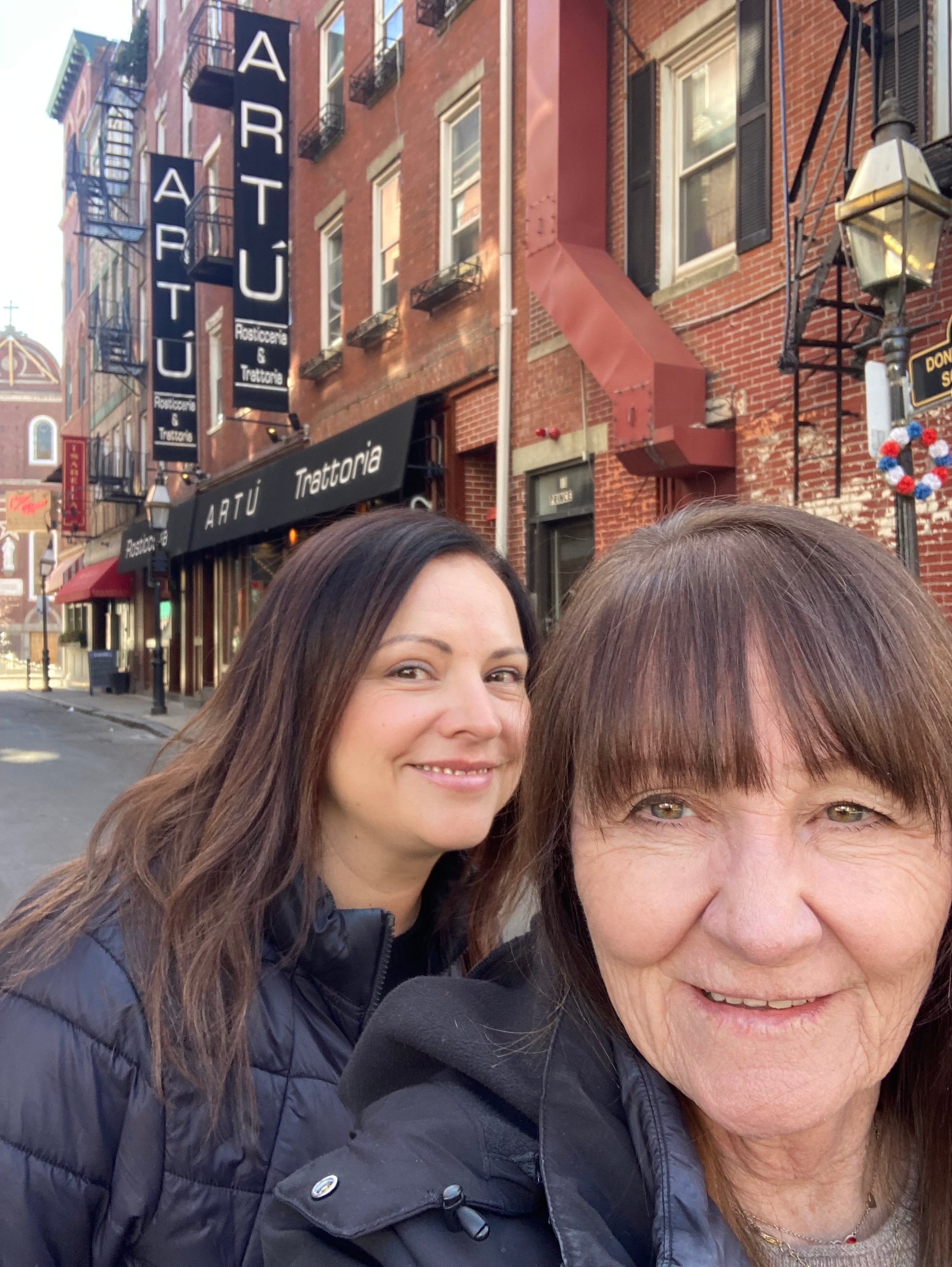 Advisor and her mother taking a selfie on a city street during the day