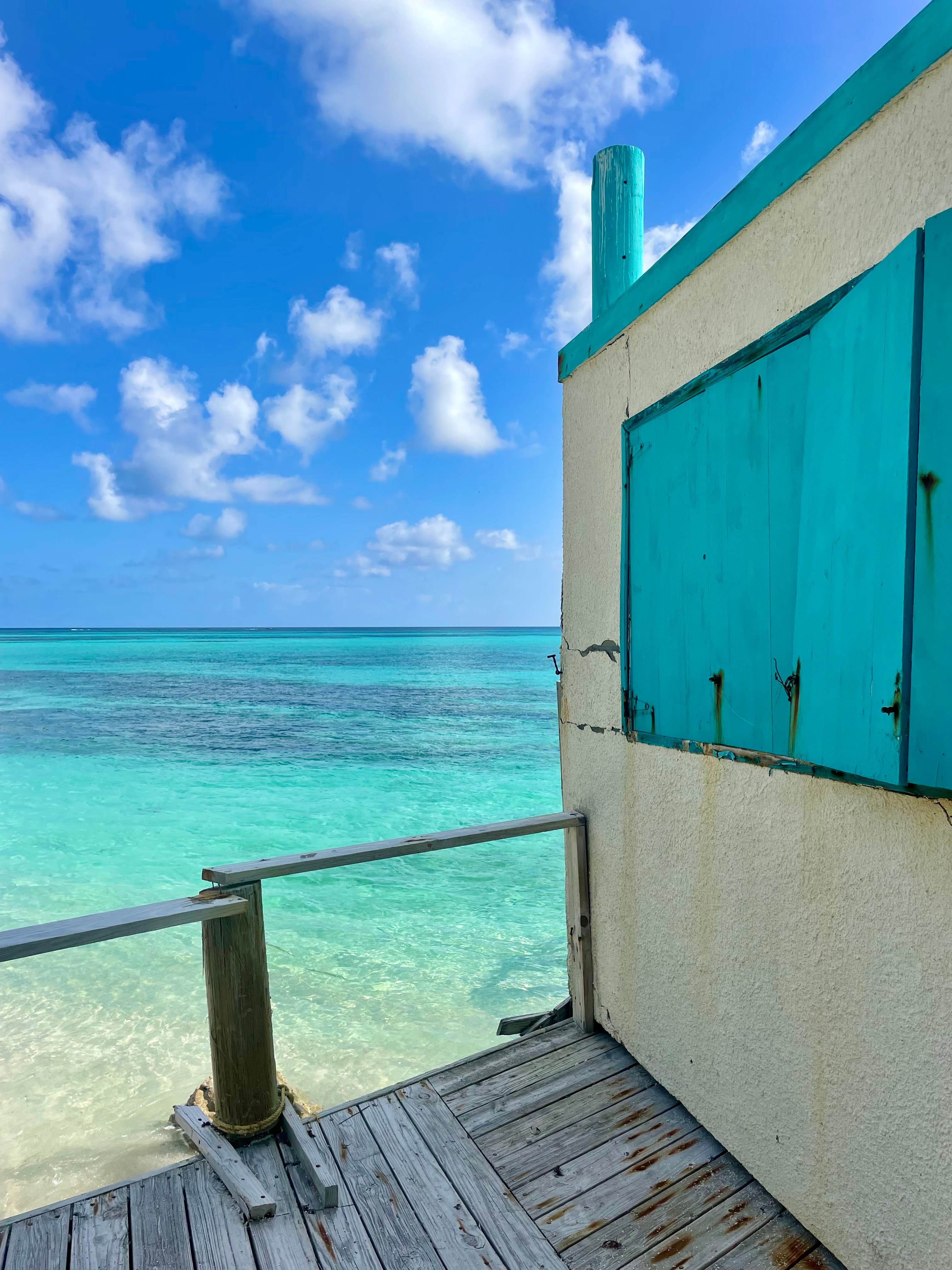 Photo of a hut with the ocean in the background during the daytime.