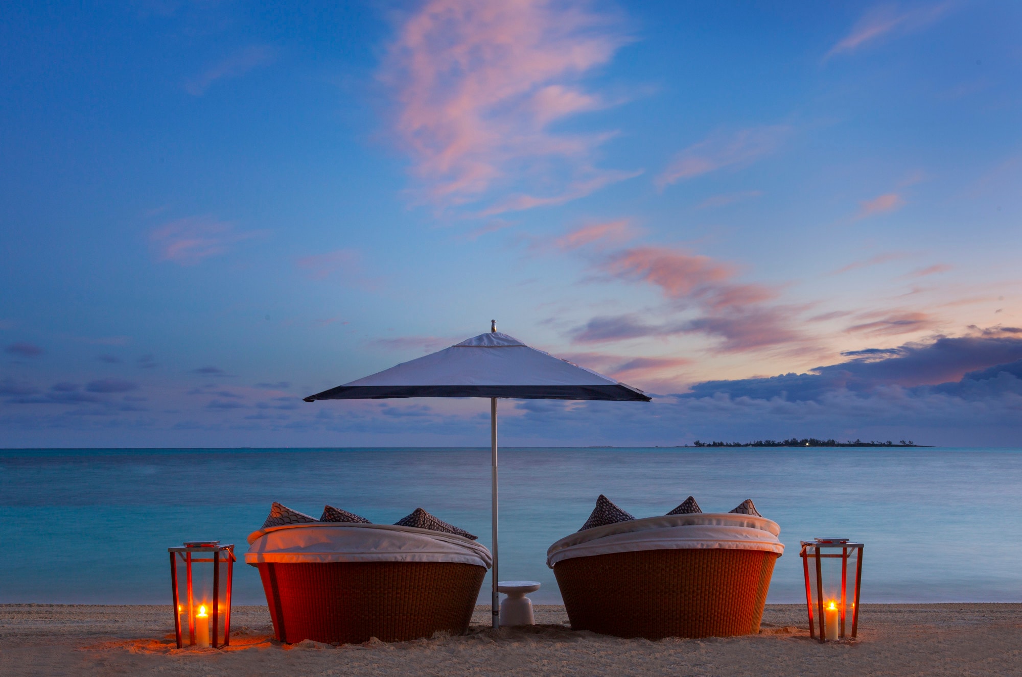 Two plush chairs overlooking ocean