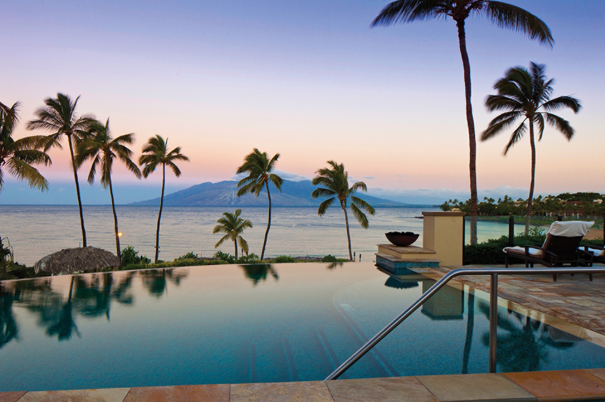 infinity pool overlooking ocean at sunset