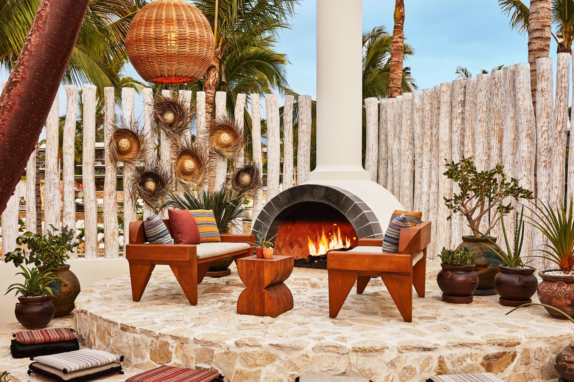 modern wooden chairs near an outdoor fire pit