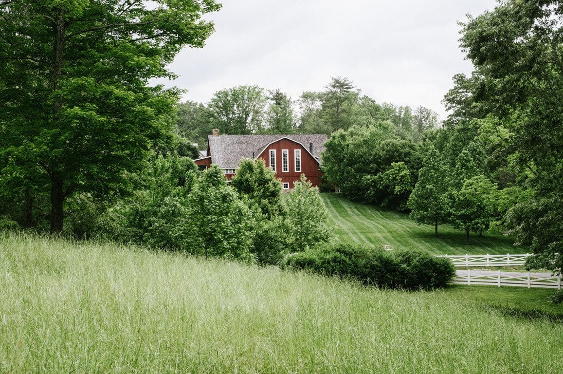 a handsome red barn amid lush greenery