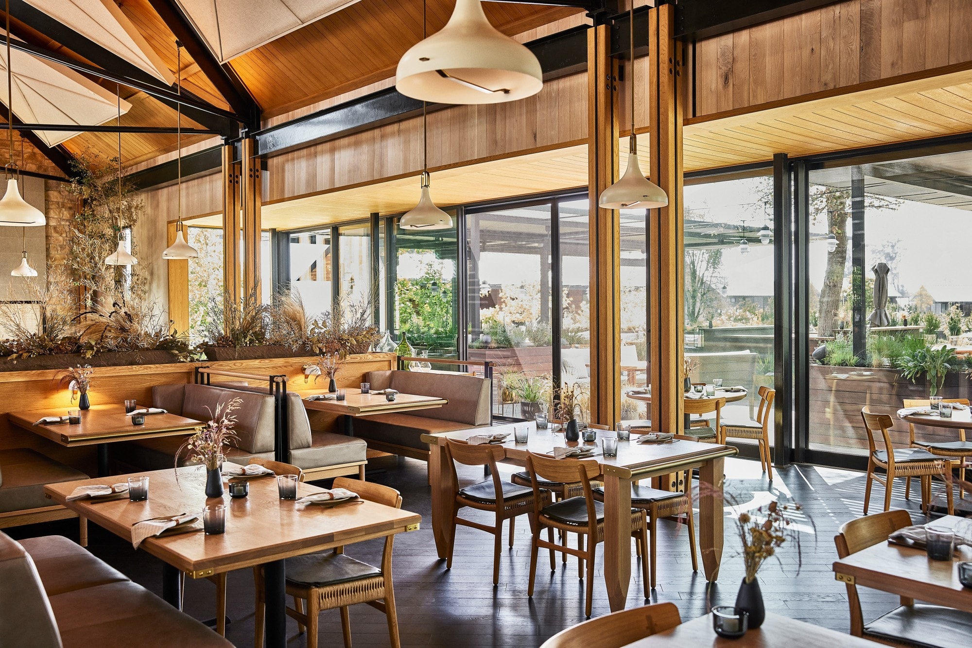 a rustic-chic dining room with towering ceilings and handsome wood furniture