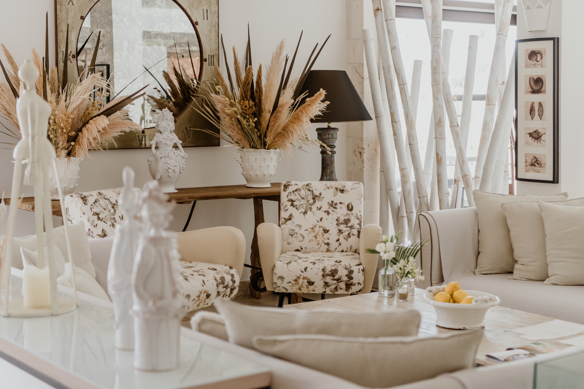 a fancy living room filled with cozy white furniture