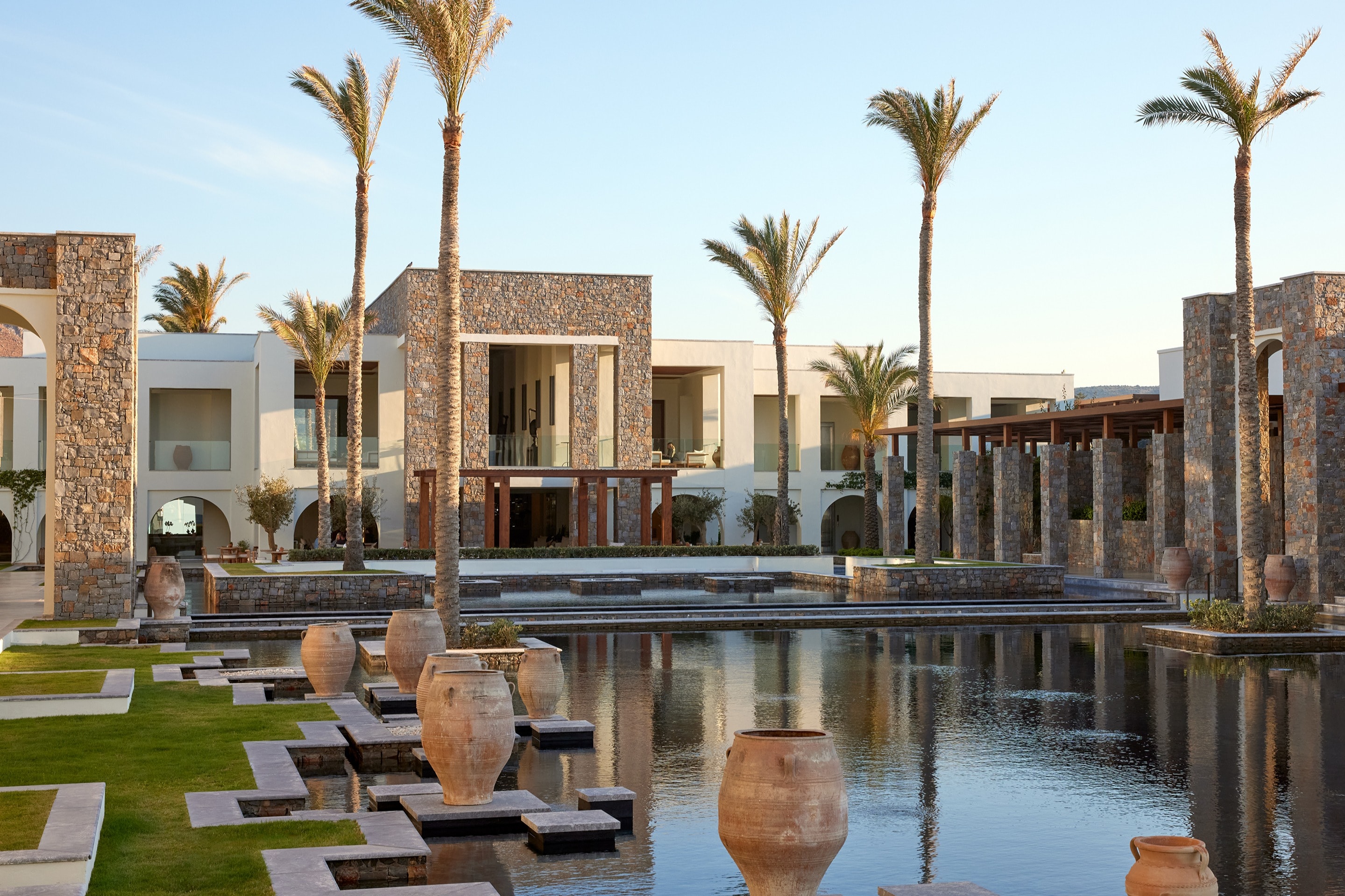 a fancy pool surrounded by stone square buildings