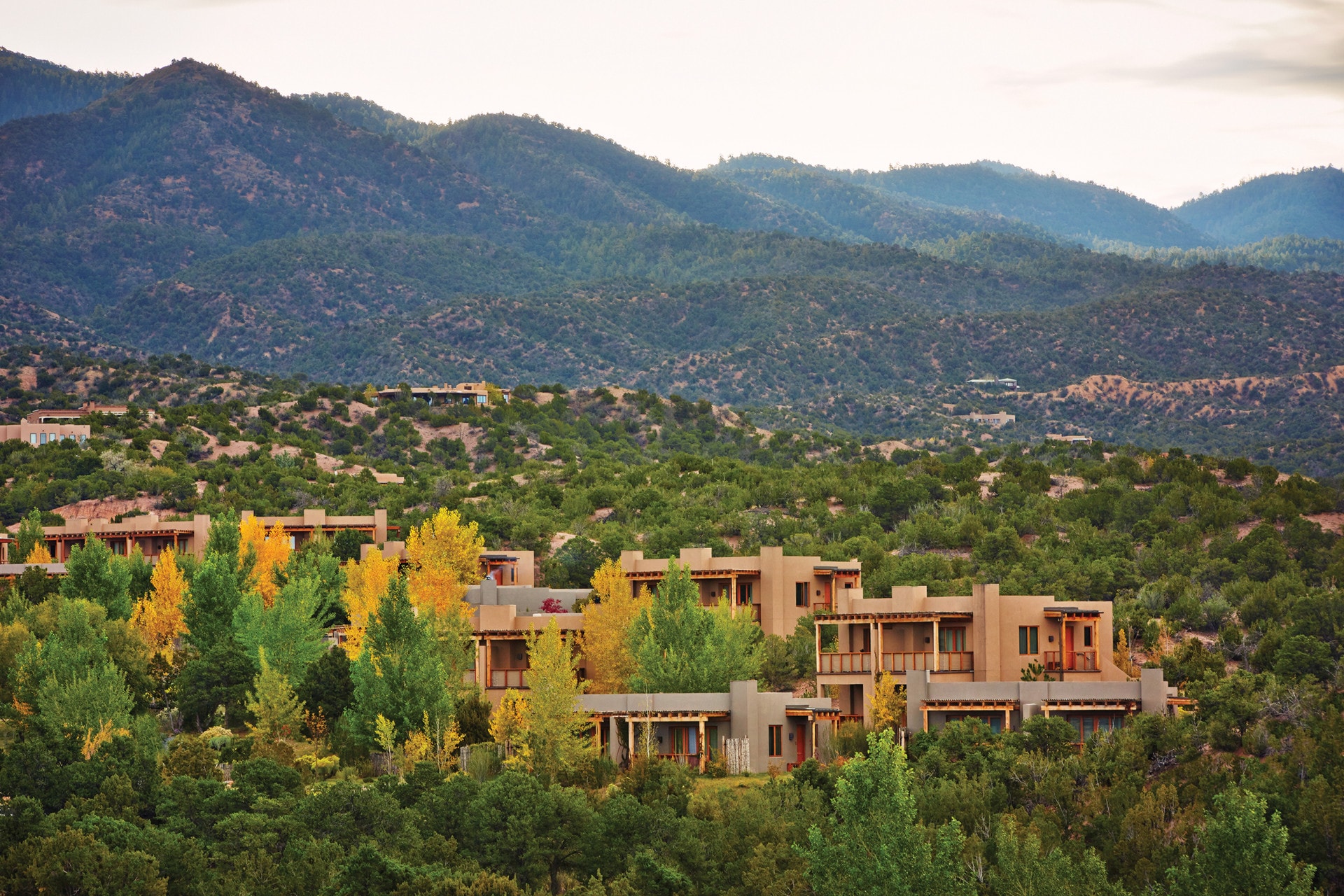 square clay structures amid a lush mountain