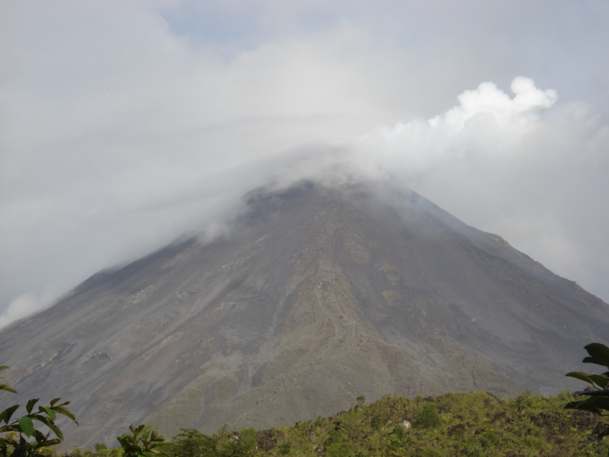 Arenal volcano with clouds covering the peak.