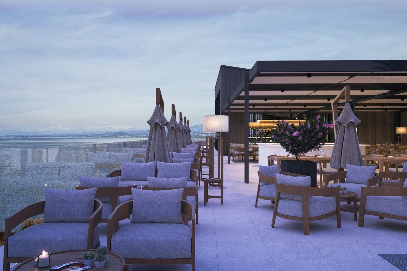 Fine dining in a natural setting at Hisa Franko on a rooftop overlooking the water at dusk.