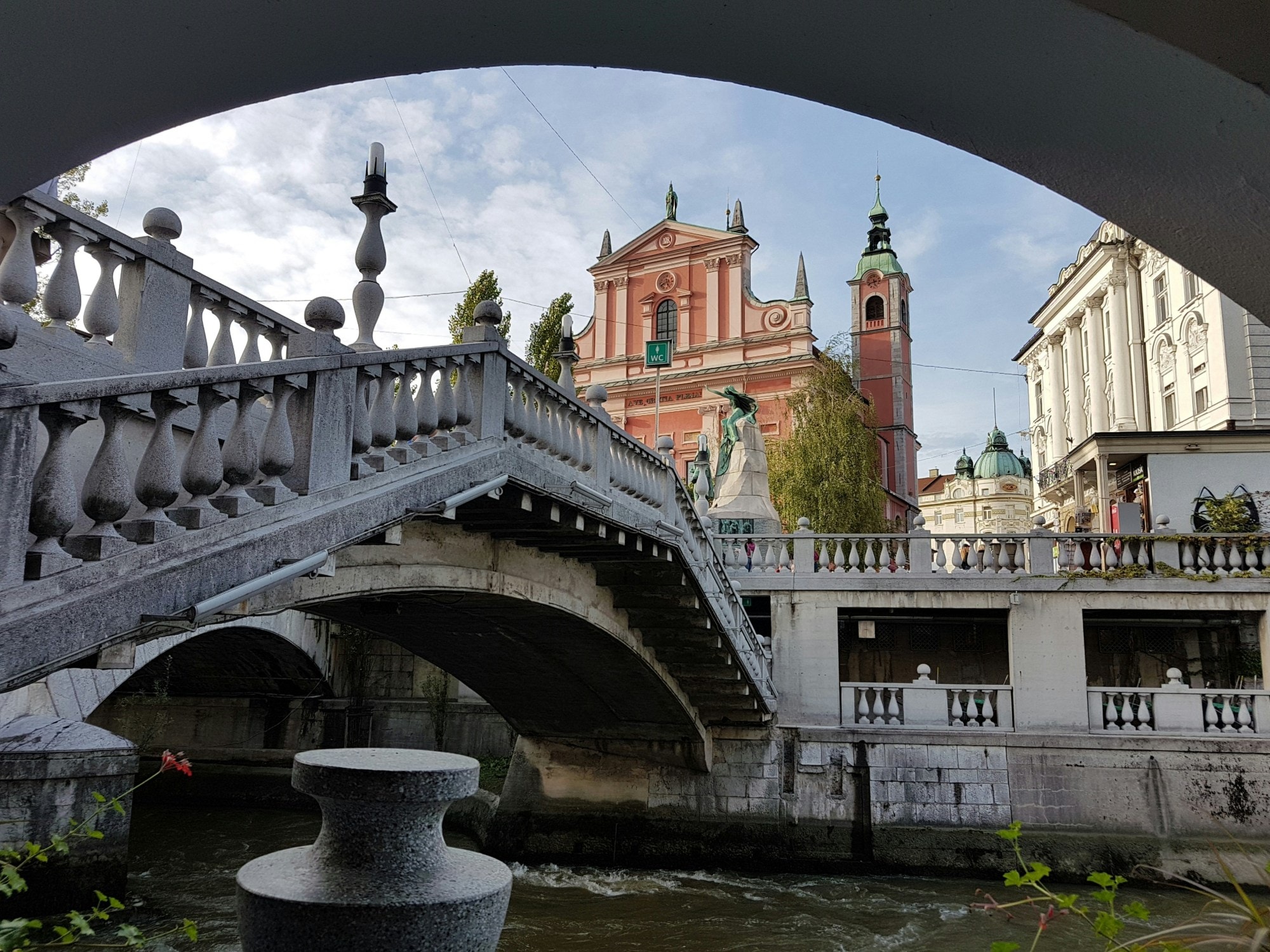 A bridge with a picturesque town in the distance during the daytime. 