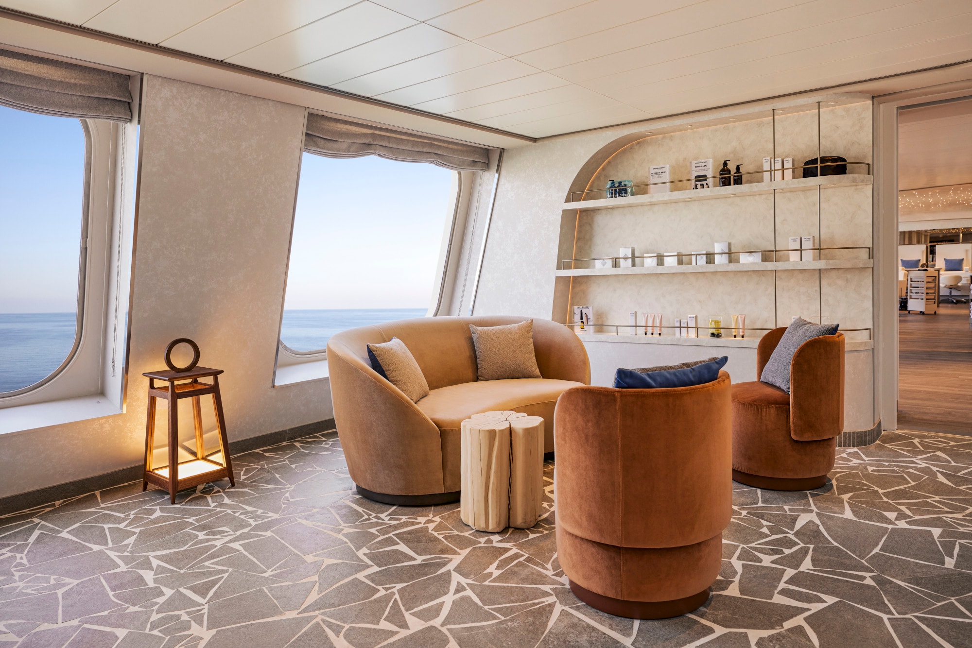 brown curved furniture in a luxe spa waiting room on an ocean cruise ship