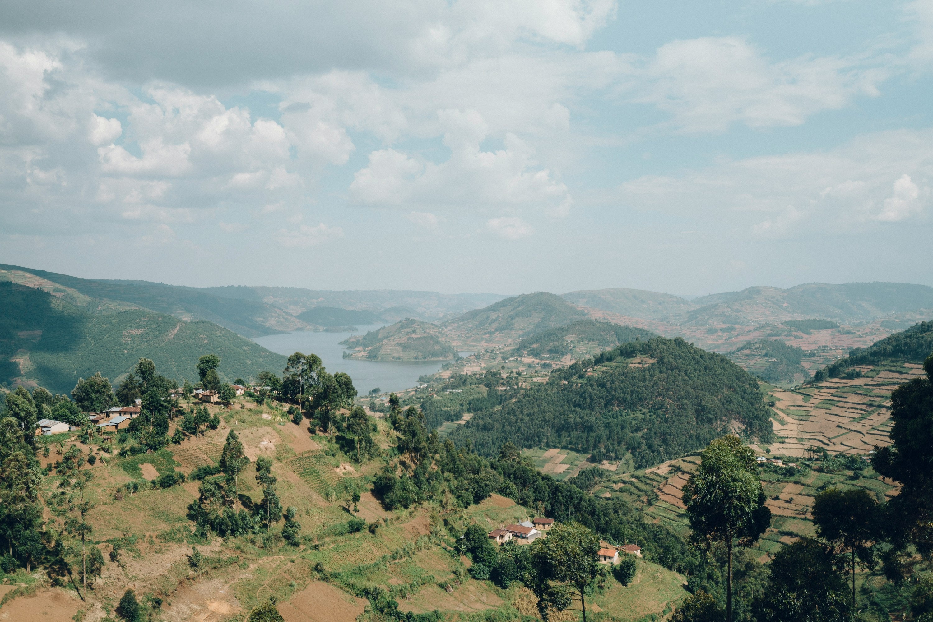 An aerial view of Lake Bunyoni in Uganda, surrounded by hills covered in trees.