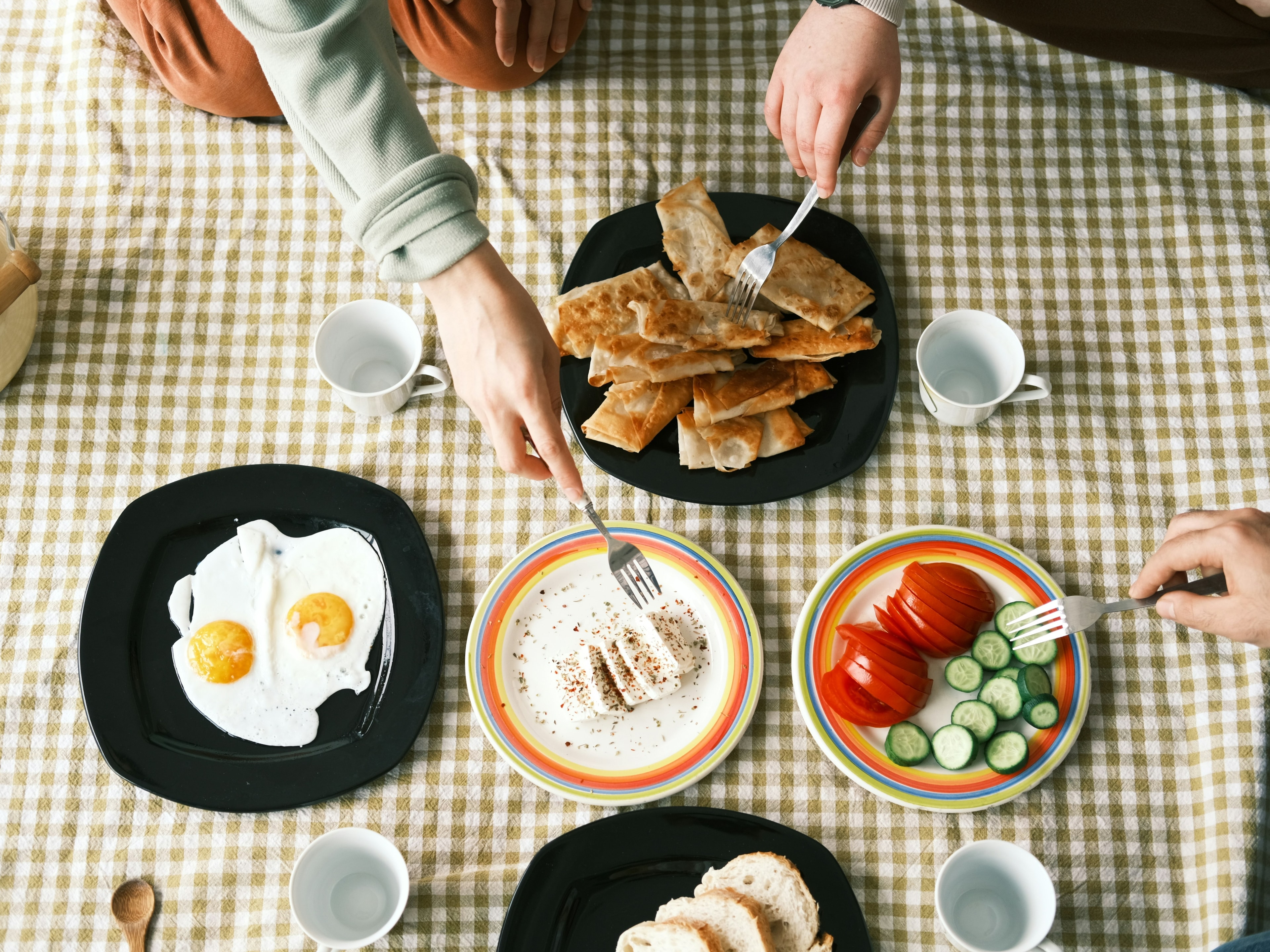 Plates of food on a gingham table cloth