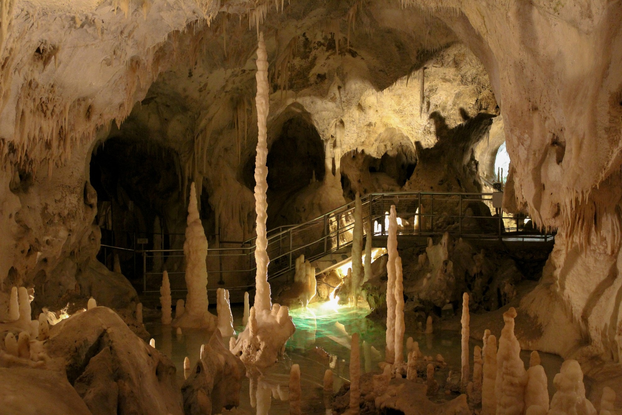 Underground cavern with rock formations and a staircase.