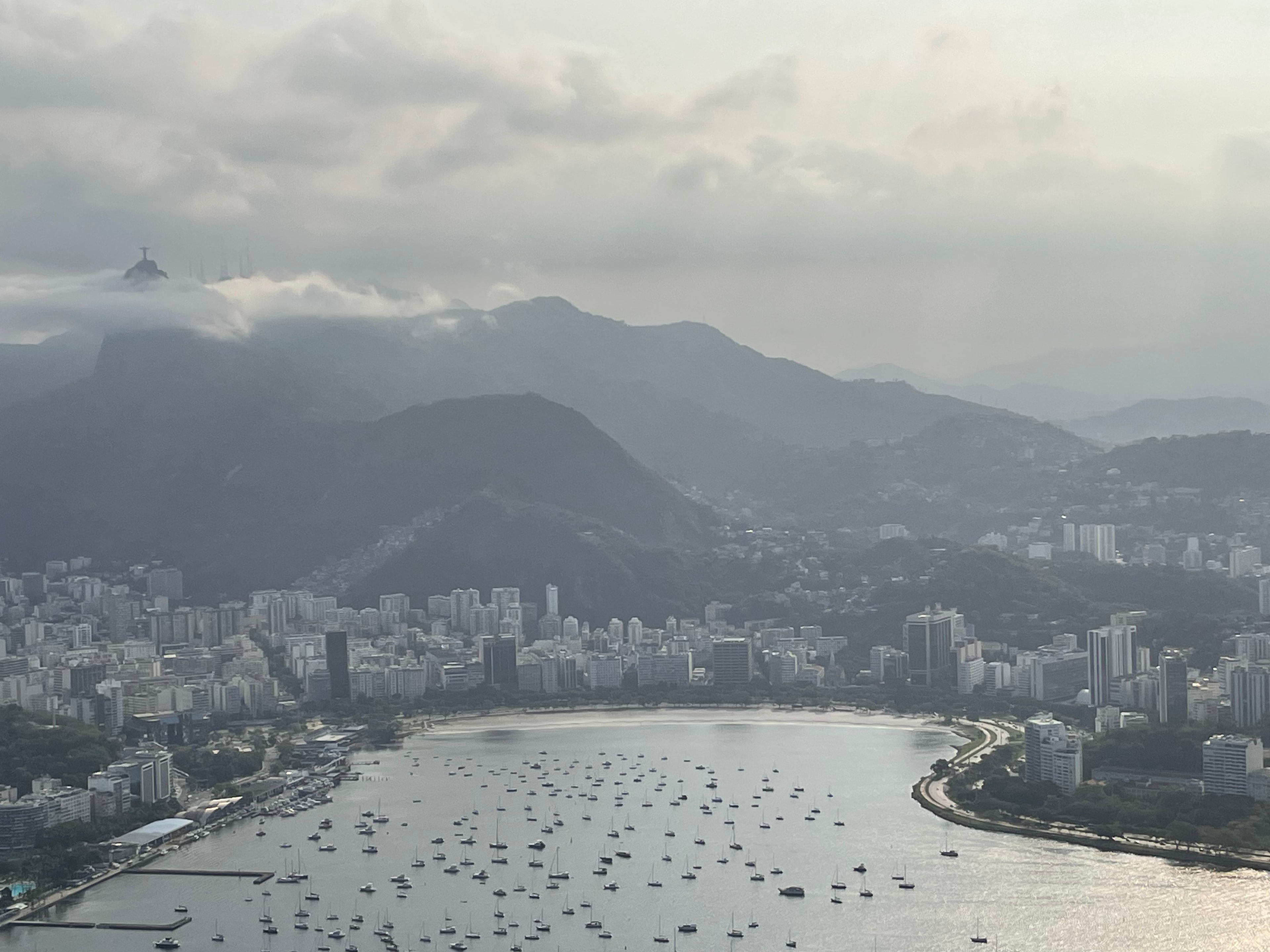 Aerial view of many small ships floating in a bay on a cloudy day