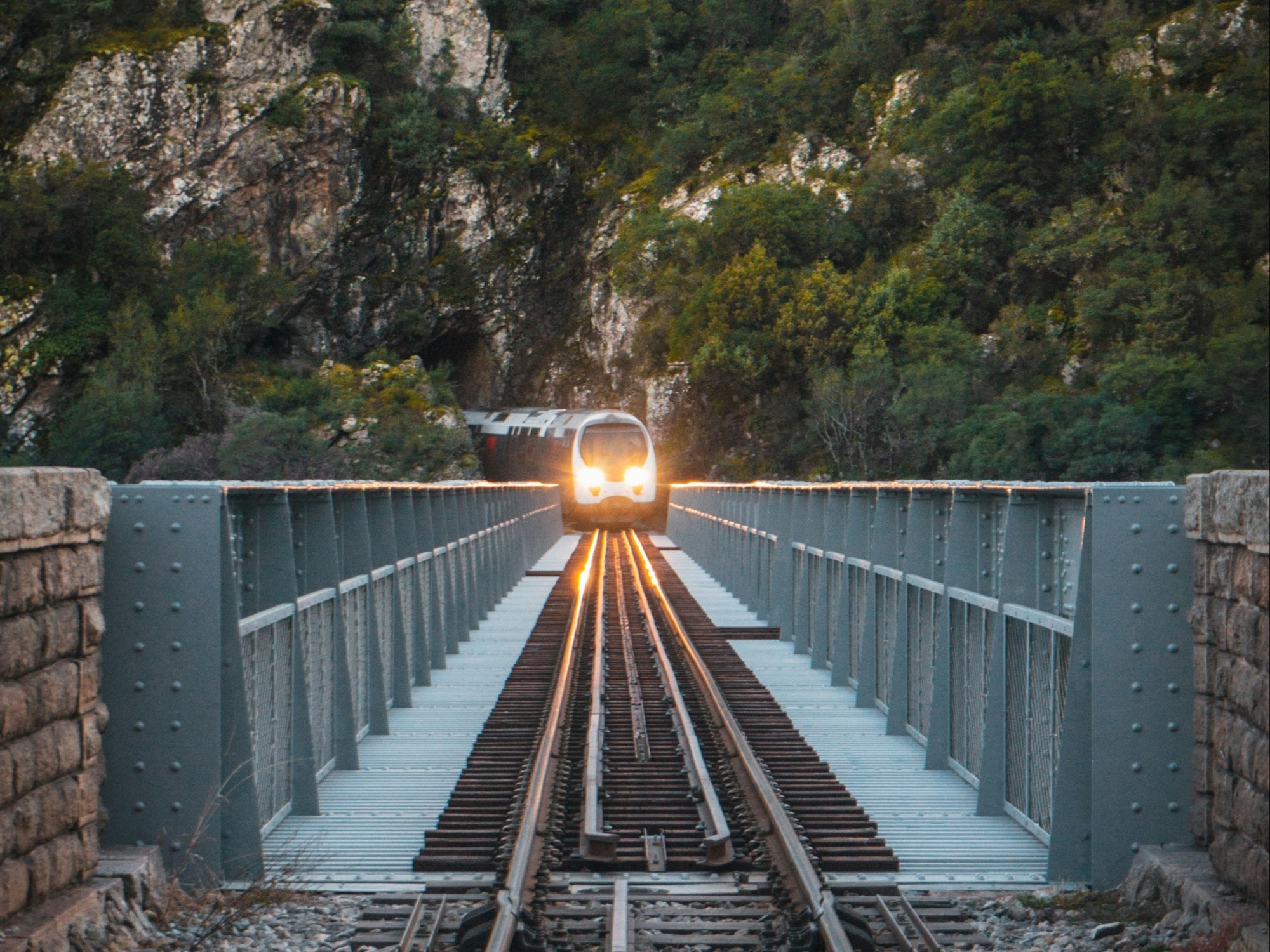 A train track with a train moving toward the camera