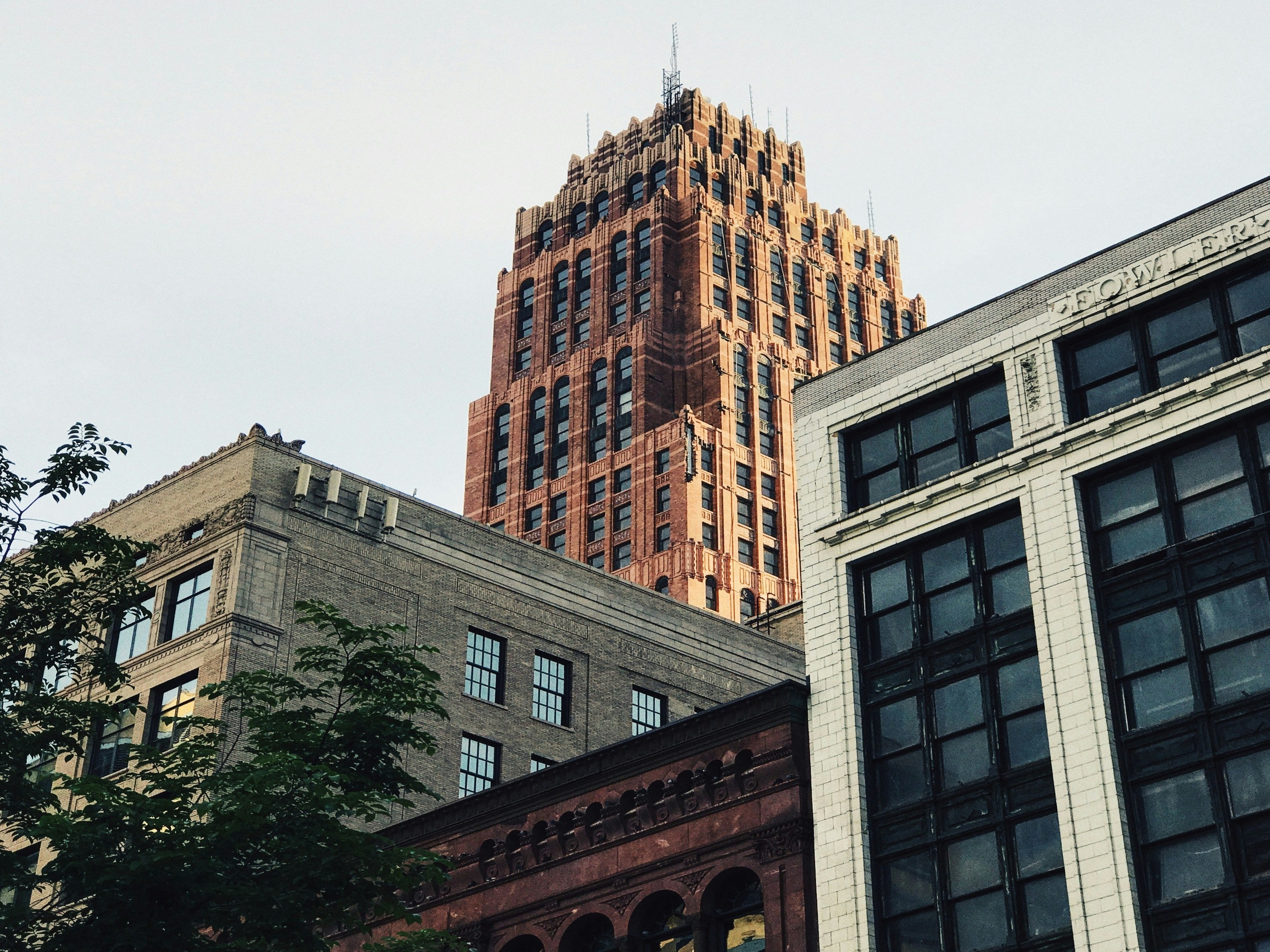 A photo from the ground of tall city buildings during the daytime