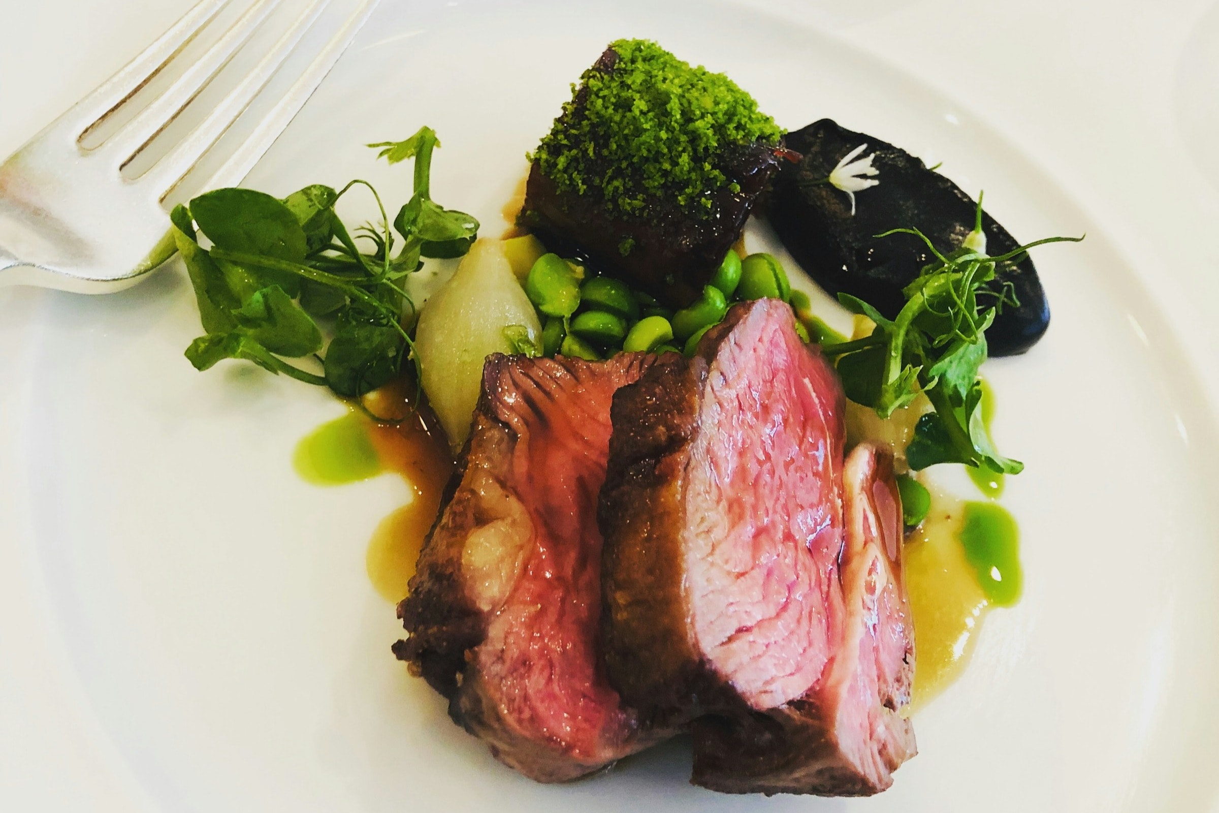 A plate of food featuring steak and vegetables