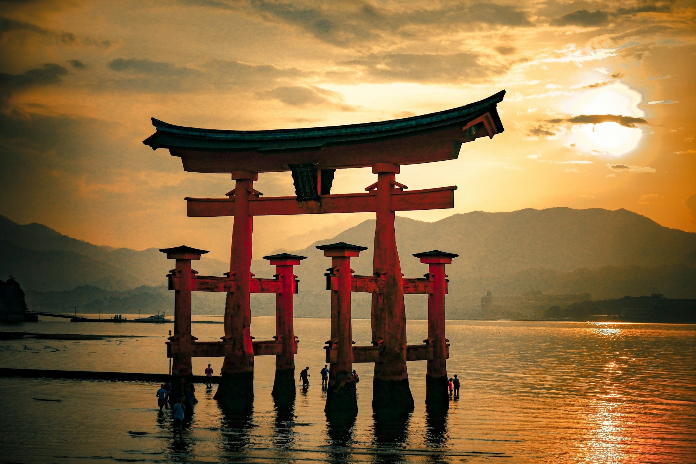 A red wooden structure in the water during a sunset