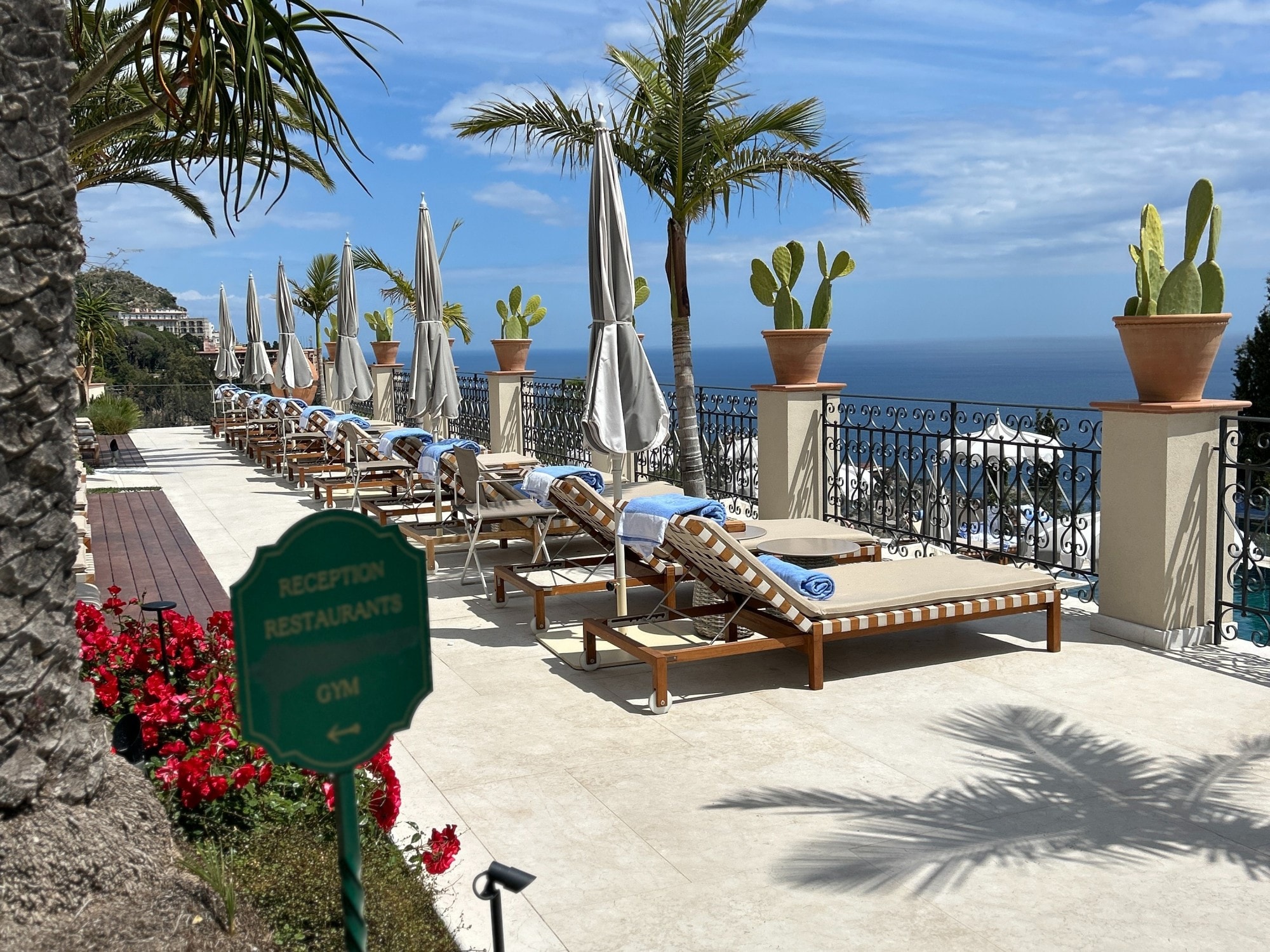 Resort with beach chairs next to a large body of water