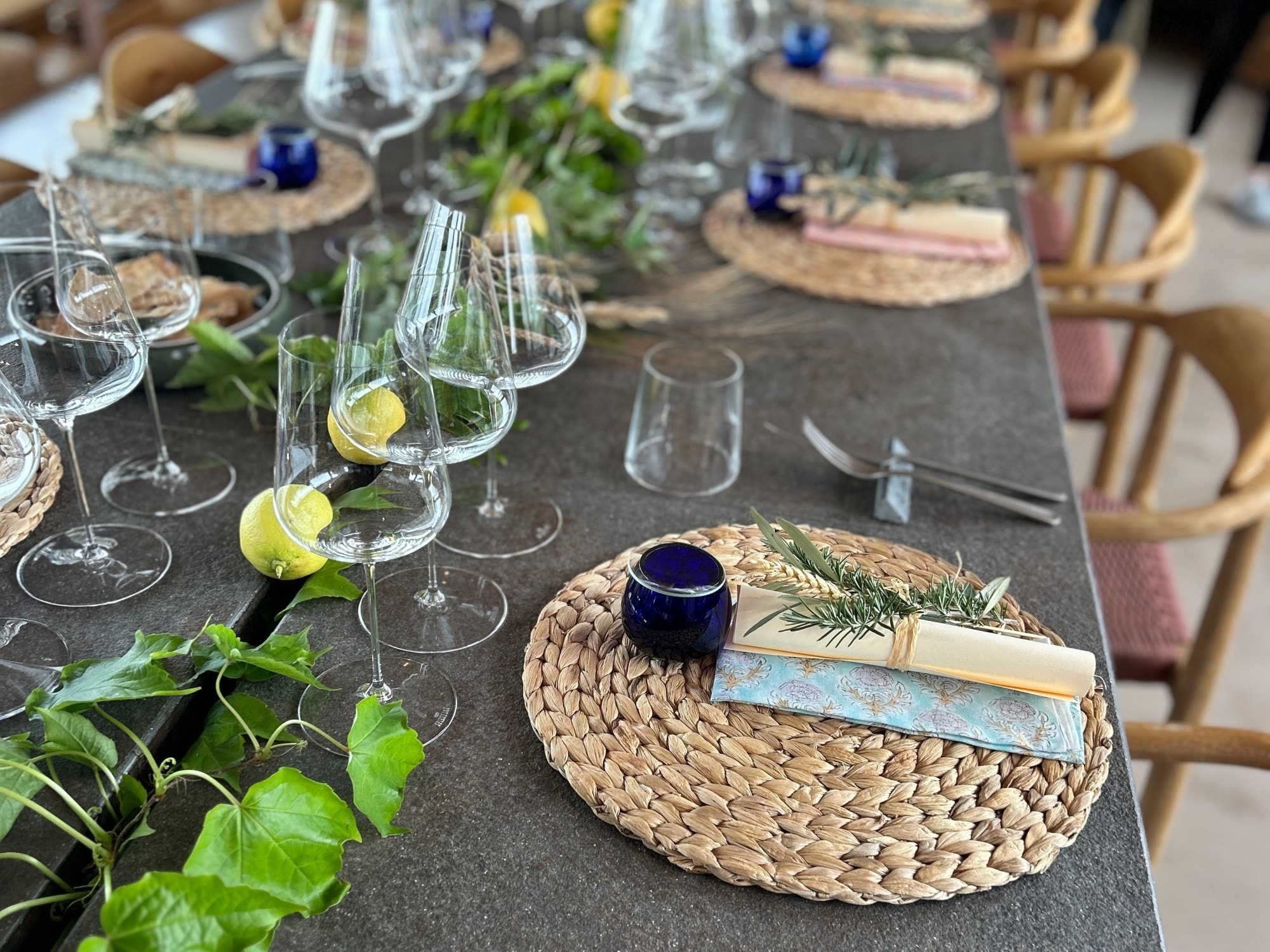 Dining table set with glasses and cutlery. 